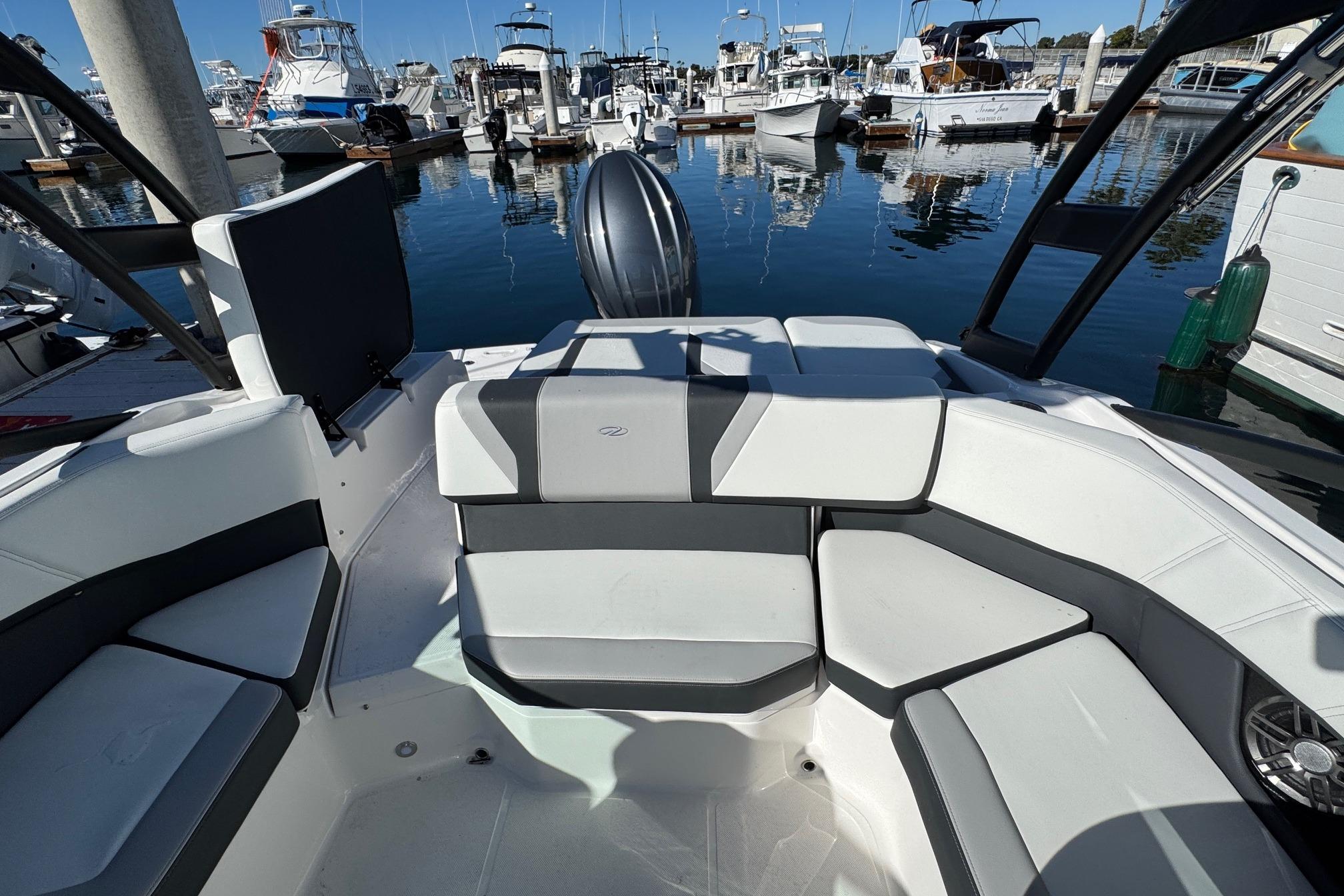 2026 Regal 21 OBX boat interior with sleek seating at a marina.