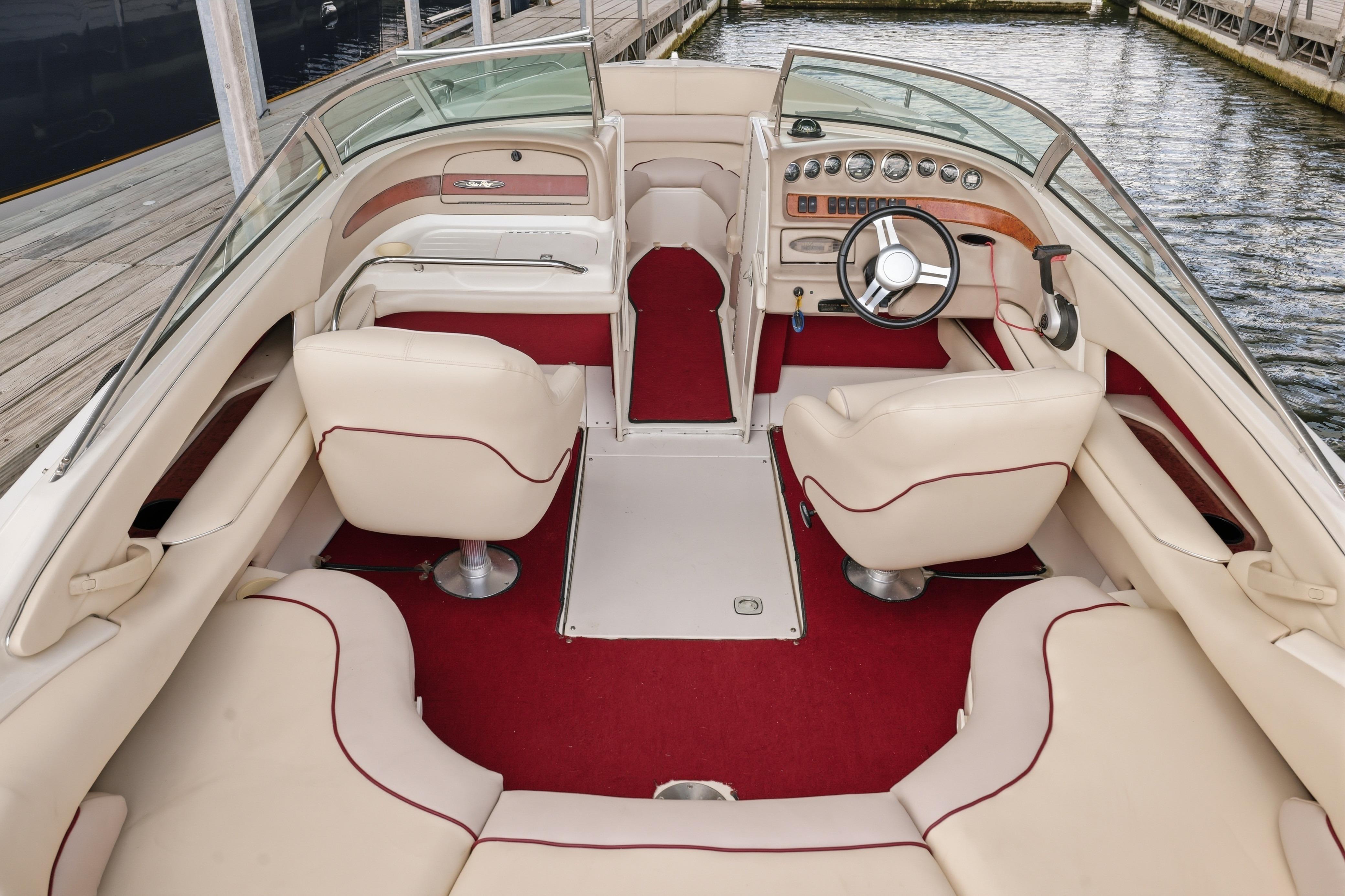 Interior of a 1997 Sea Ray 230 Signature boat with red and cream seating.