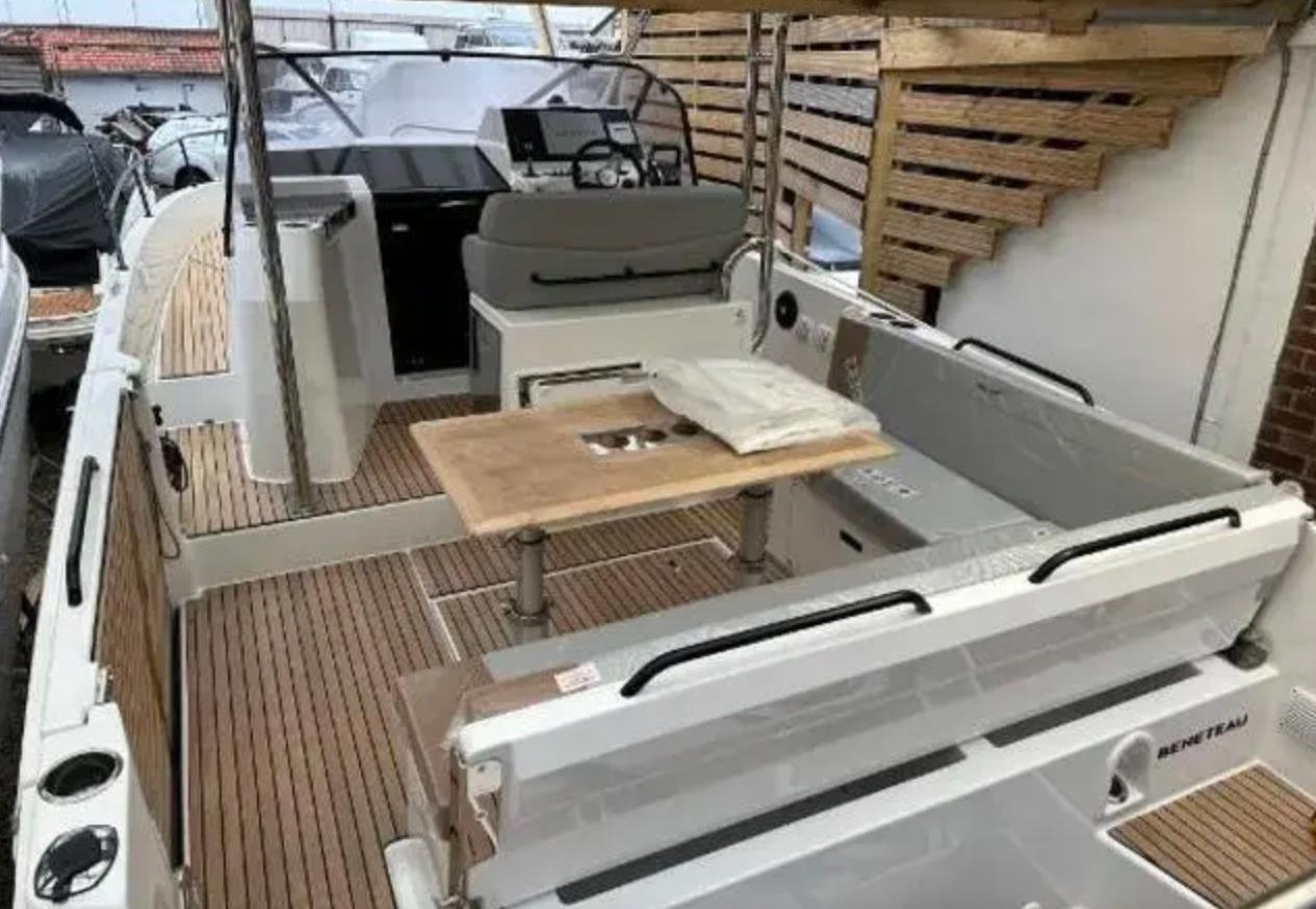 2023 Beneteau Flyer 9 boat interior with wooden deck and seating area.