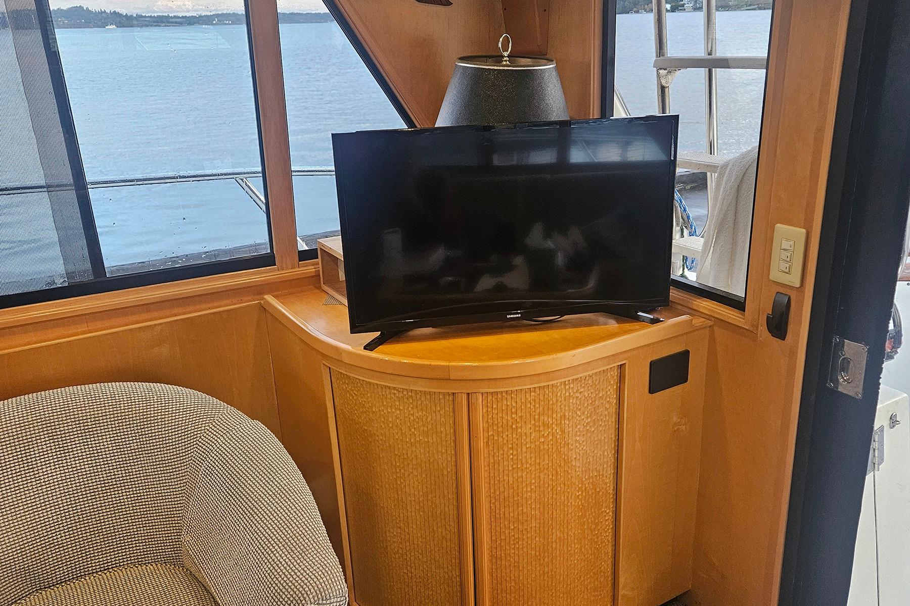 Interior of a 1995 Symbol 55 yacht with TV and scenic window view.