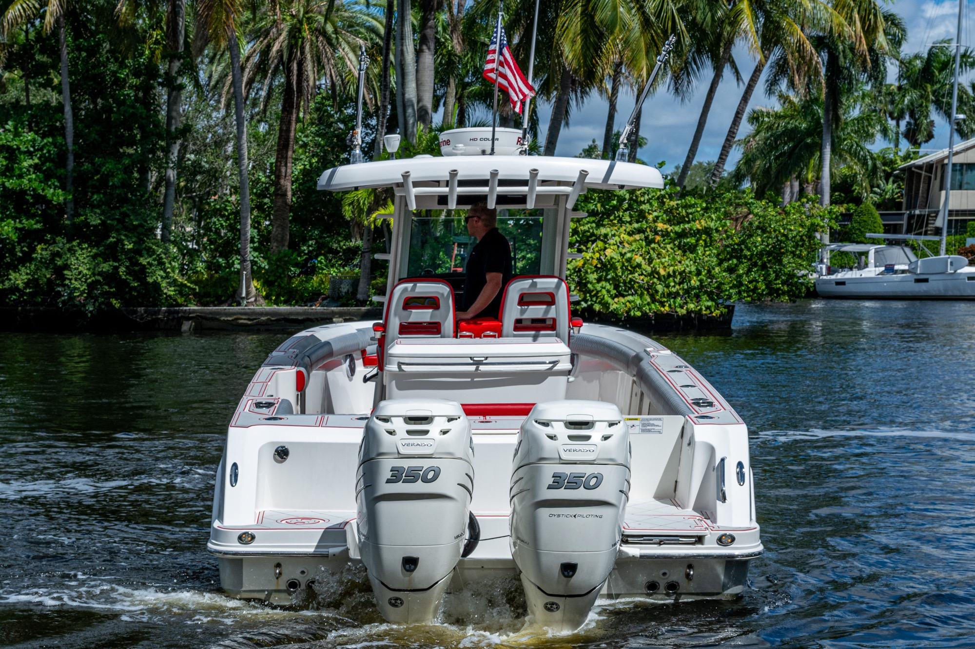 2018 Boston Whaler 330 boat with dual 350 engines on a scenic waterway.