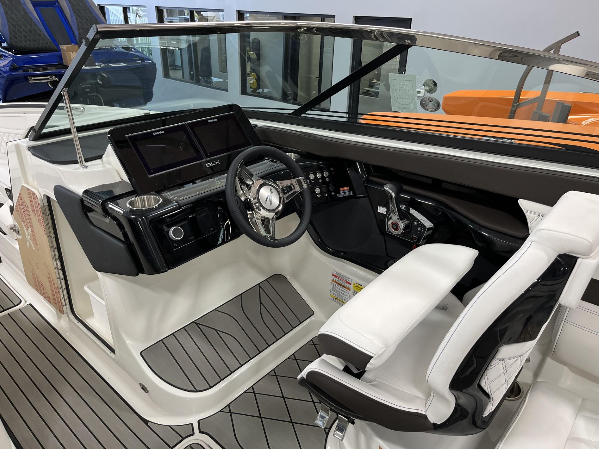 2024 Sea Ray SLX 260 boat cockpit with modern controls and white seating.