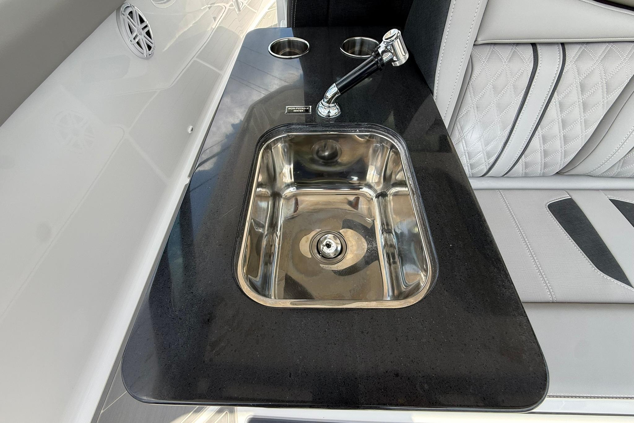 Luxury sink area on 2027 Monterey Elite 30 OB boat with sleek design and modern fixtures.