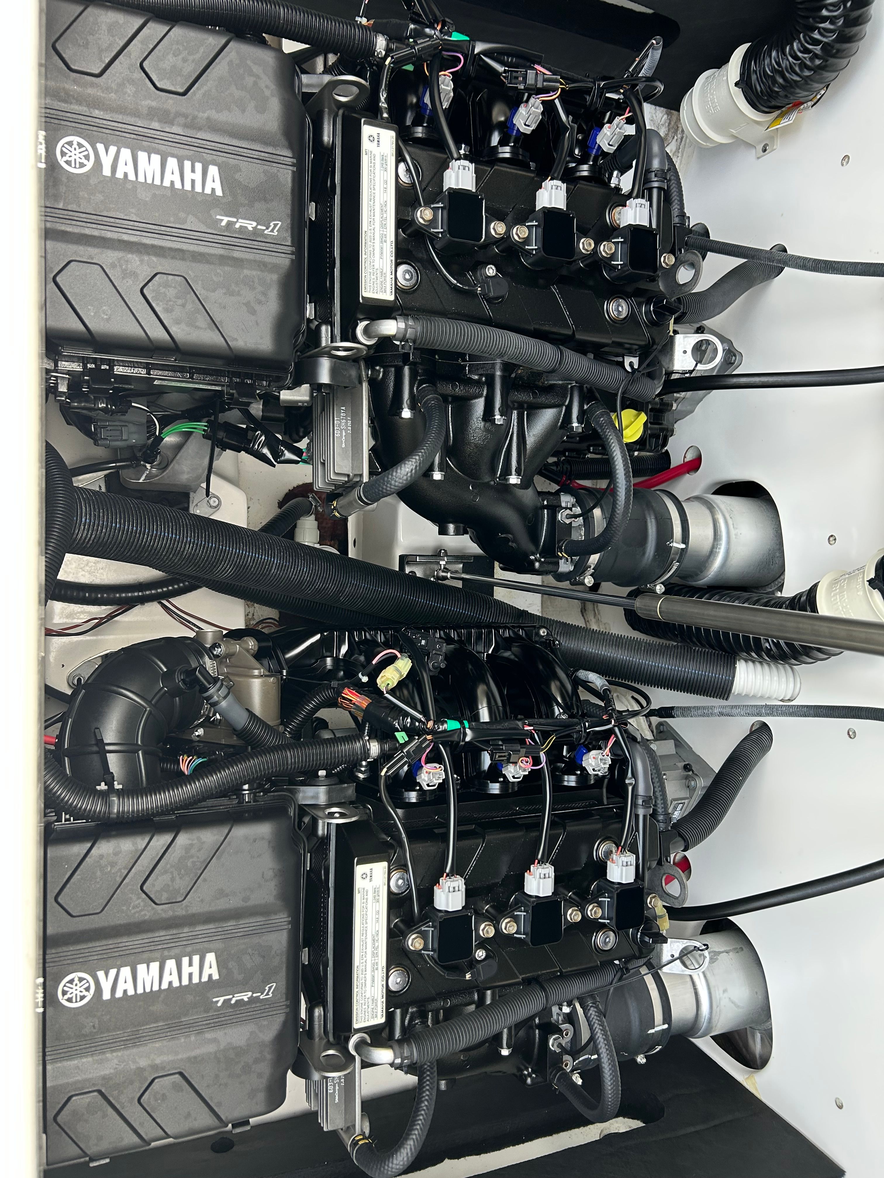 Two Yamaha engines in a boat's engine compartment, clean and well-organized.