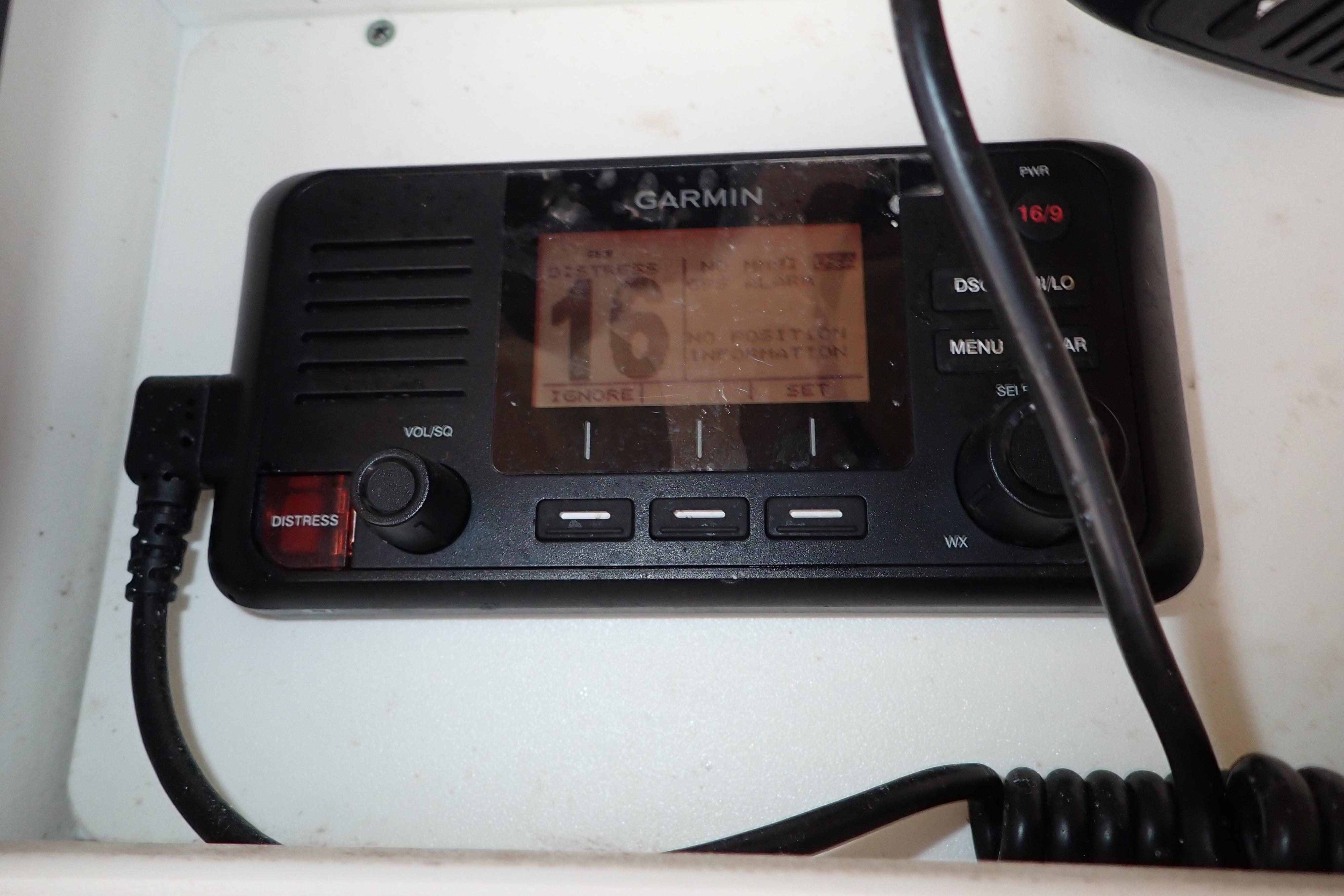 Garmin marine radio on 2019 Key West 263 FS boat, featuring distress button and display.