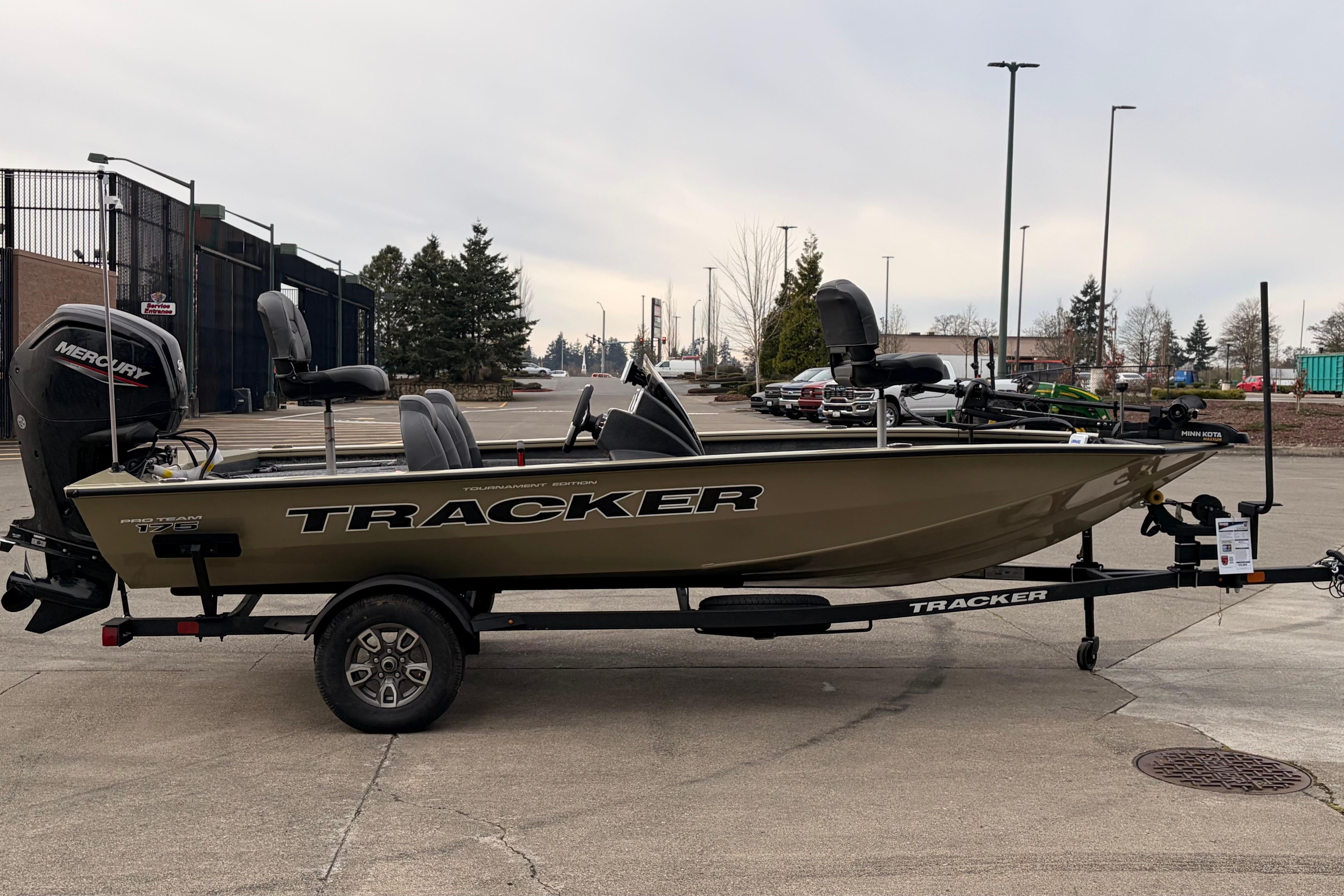 2026 Tracker Pro Team 175 fishing boat on trailer, parked outdoors.