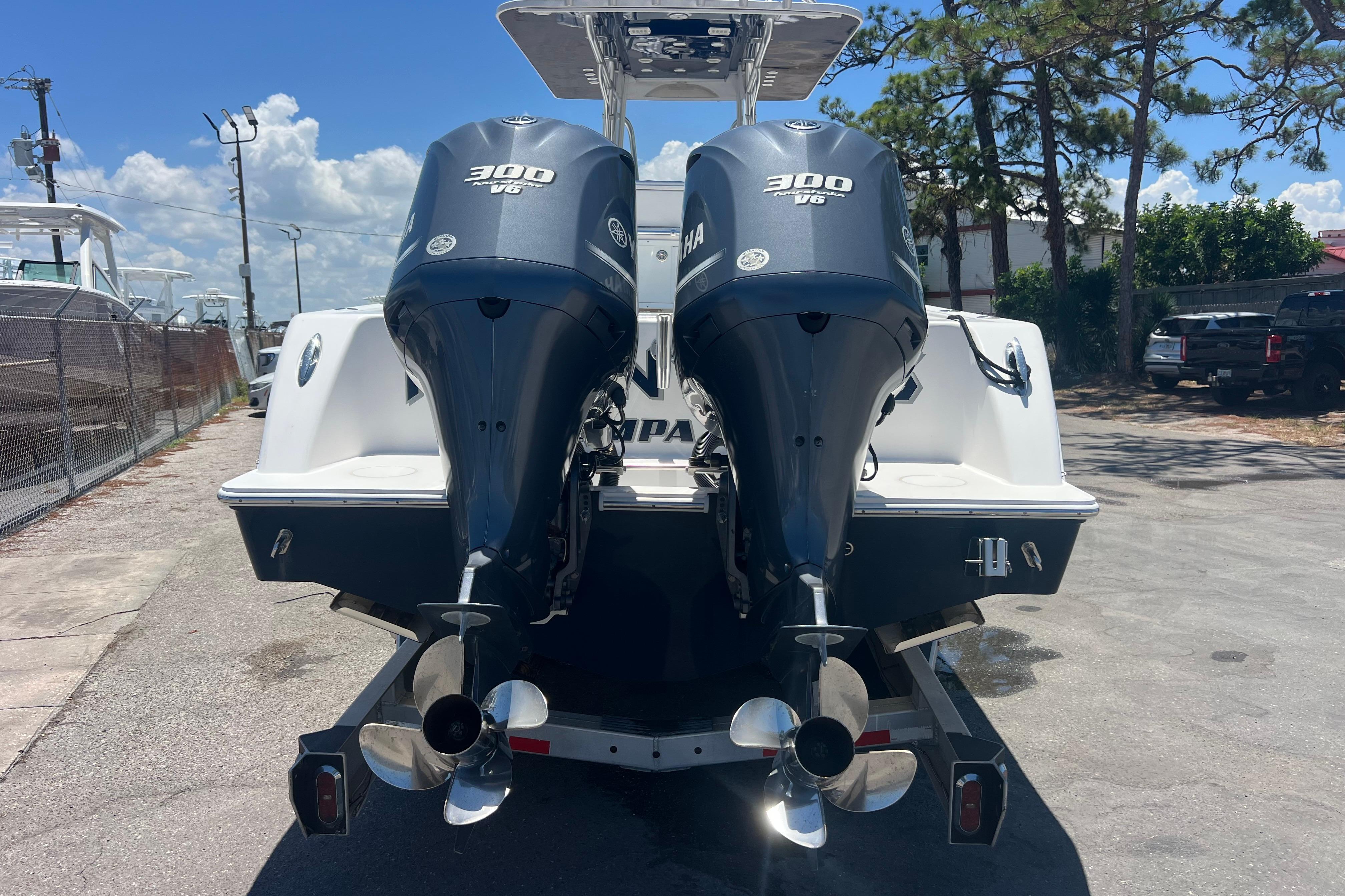 2012 Invincible 33 Open Fisherman with twin Yamaha 300 engines, parked outdoors.