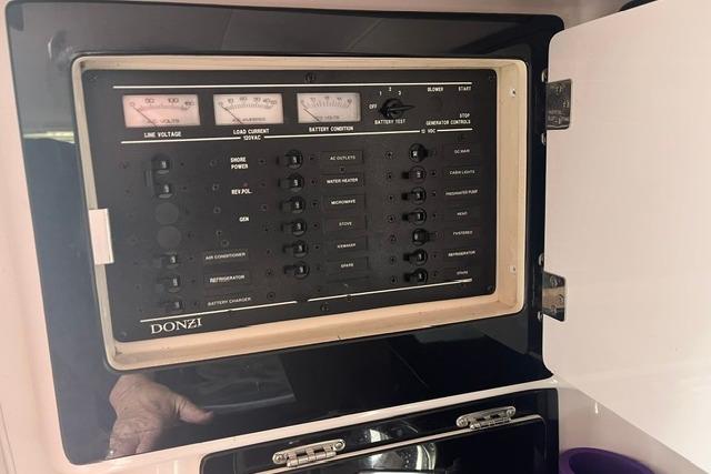 Control panel of a 2000 Donzi 33 ZX boat, featuring various switches and gauges.