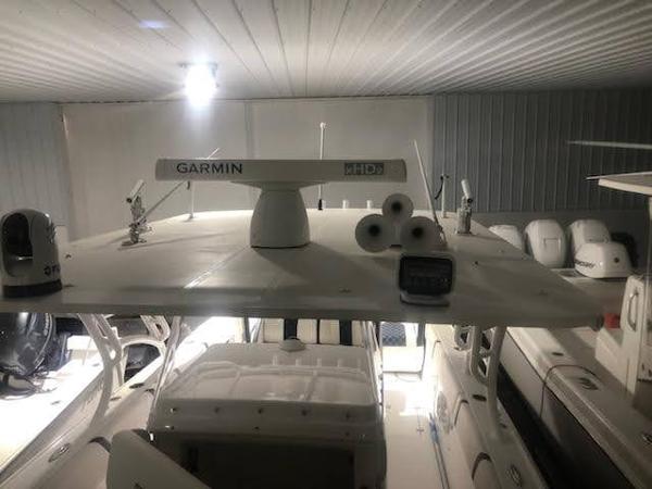 2019 Midnight Express 39 Cuddy boat with Garmin radar in a storage facility.