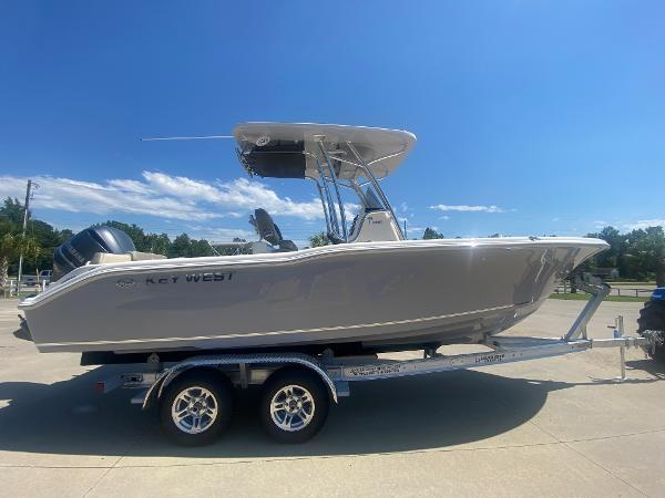 2024 Key West 239 FS boat on a trailer under a clear blue sky.