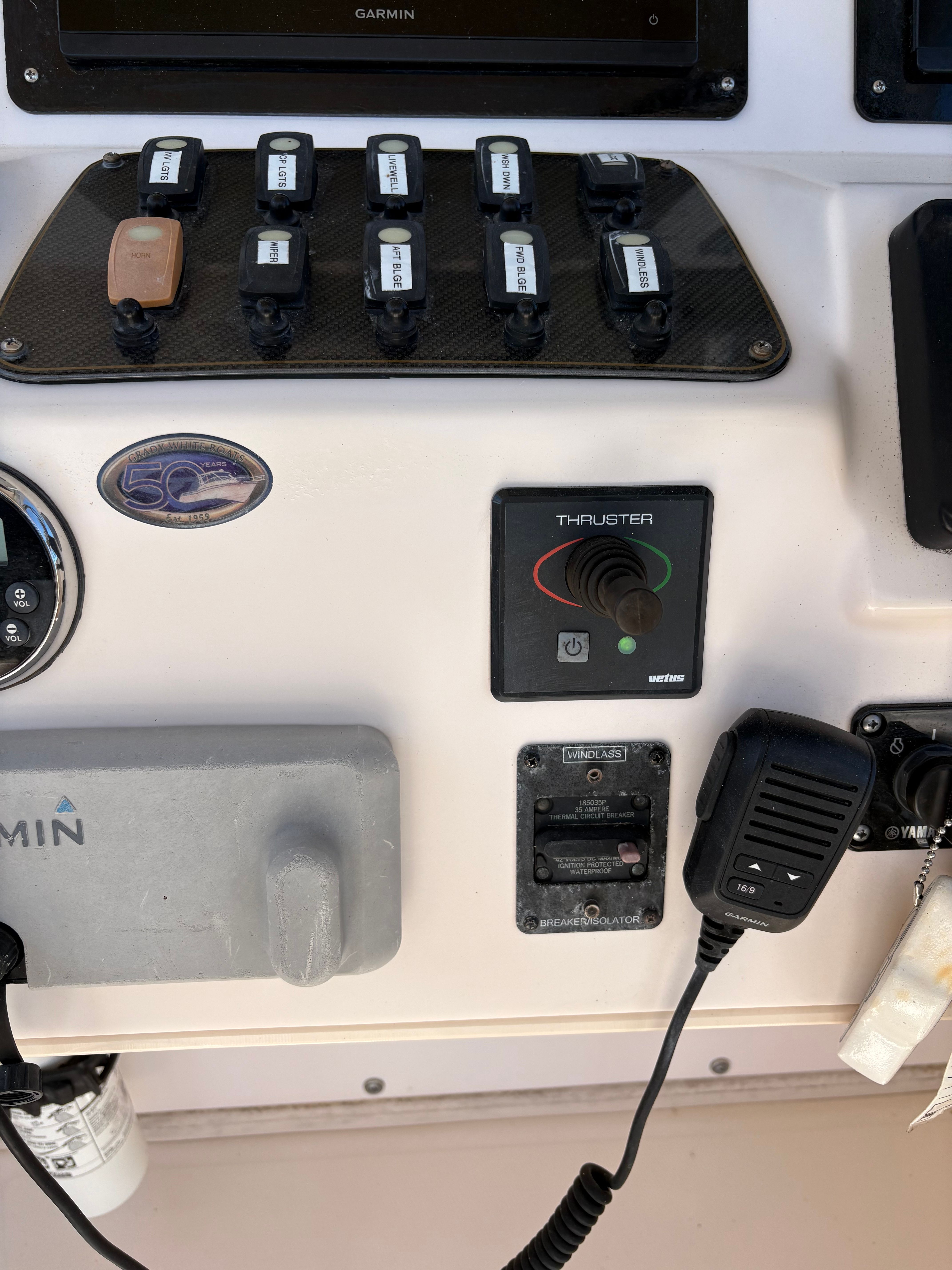Control panel of 2009 Grady-White Chesapeake 290 with switches and microphone.