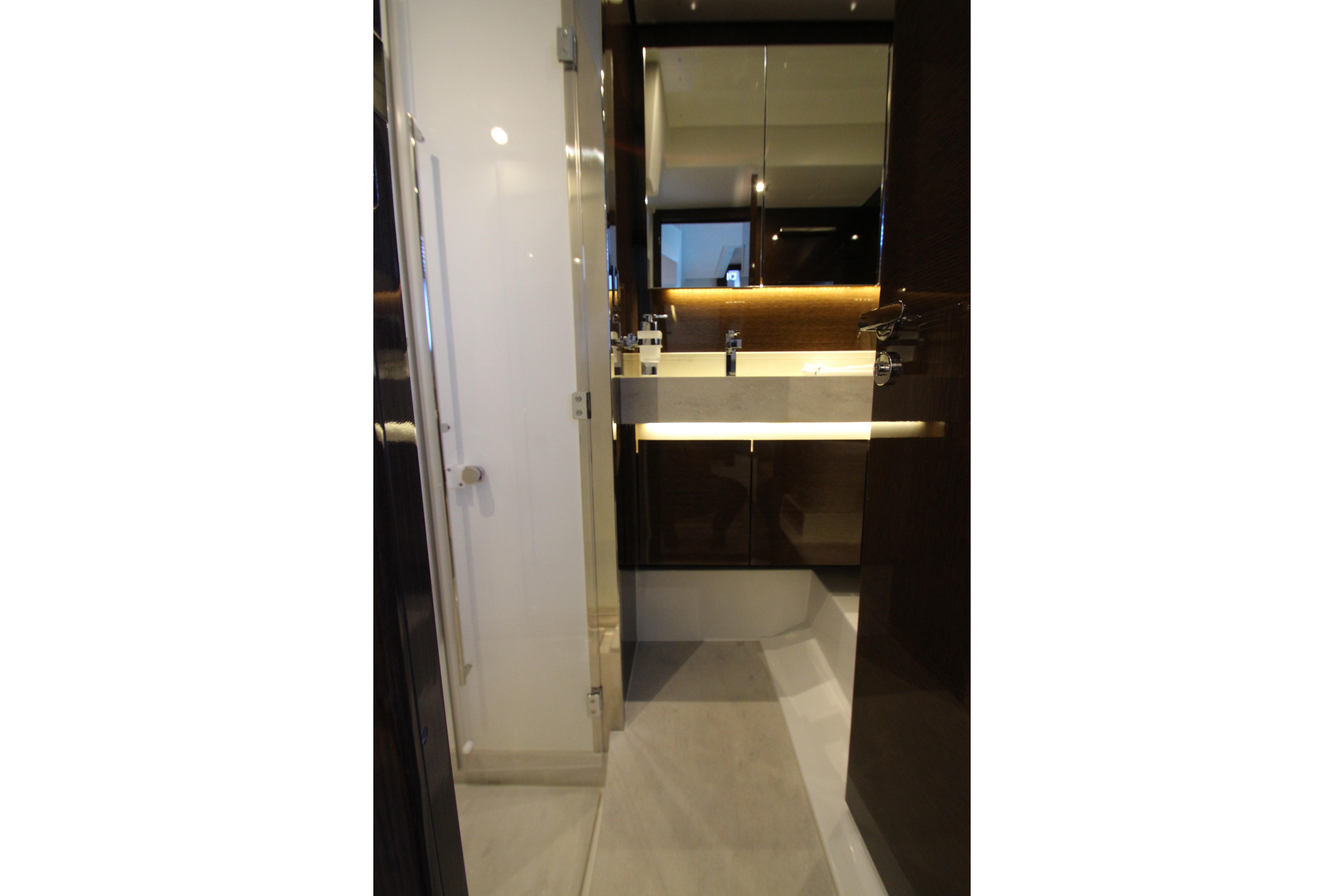 Luxurious bathroom interior of 2022 Prestige 520 yacht, featuring modern sink and elegant lighting.