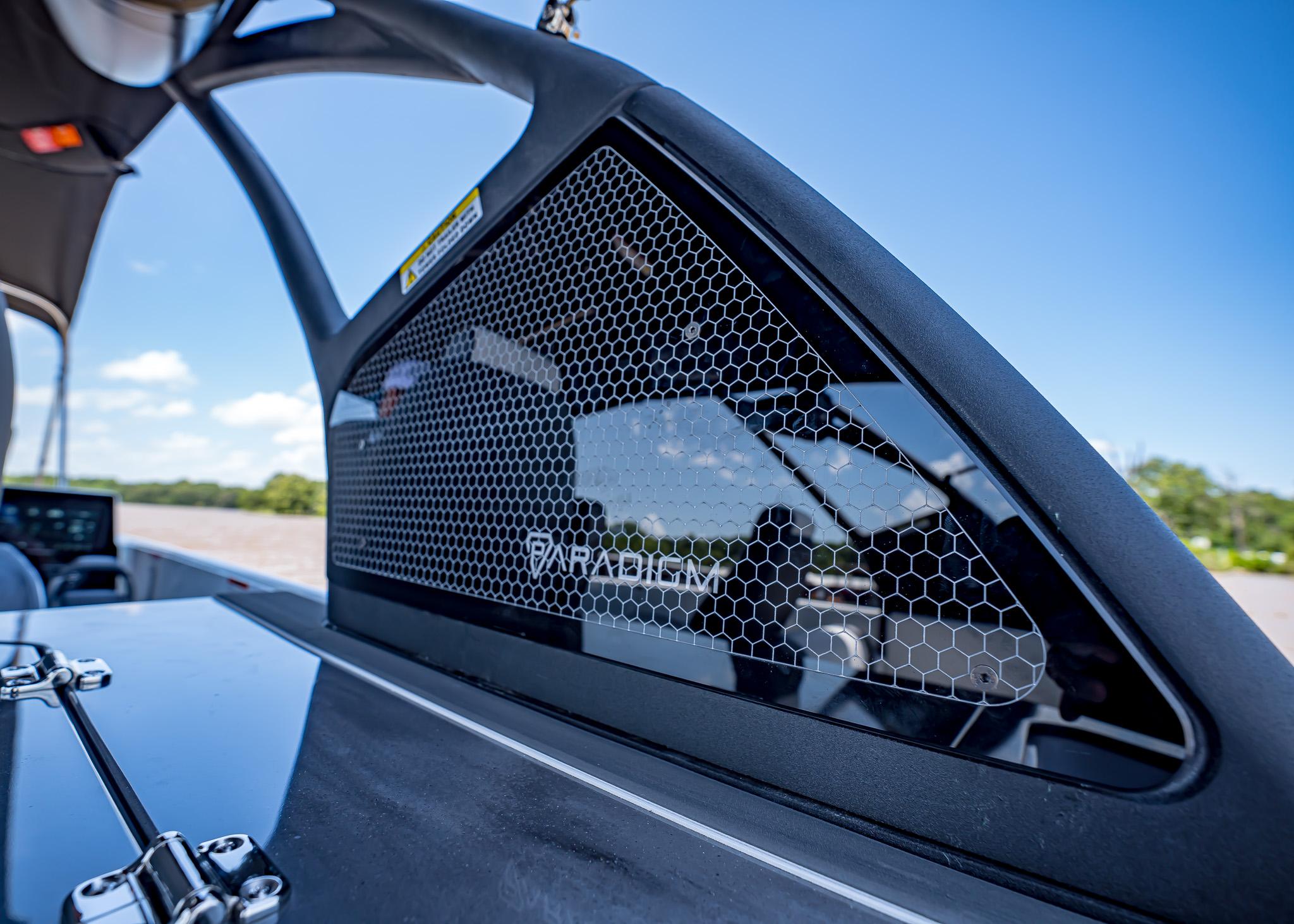 2025 Paradigm Damascus 266 Surf boat with sleek design and hexagonal mesh detail.