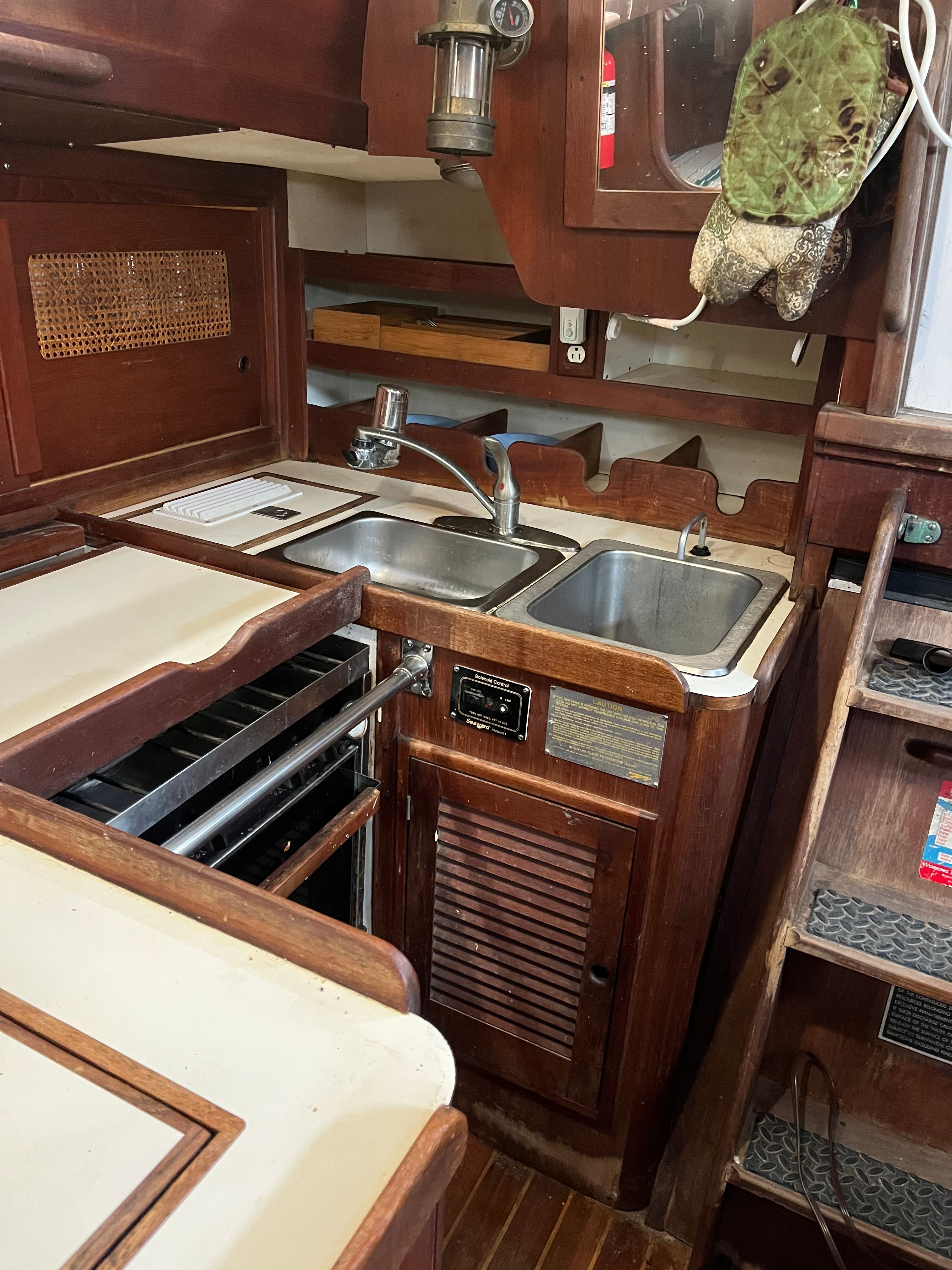 Interior view of a 1981 Tartan Sloop featuring a kitchen and sink.