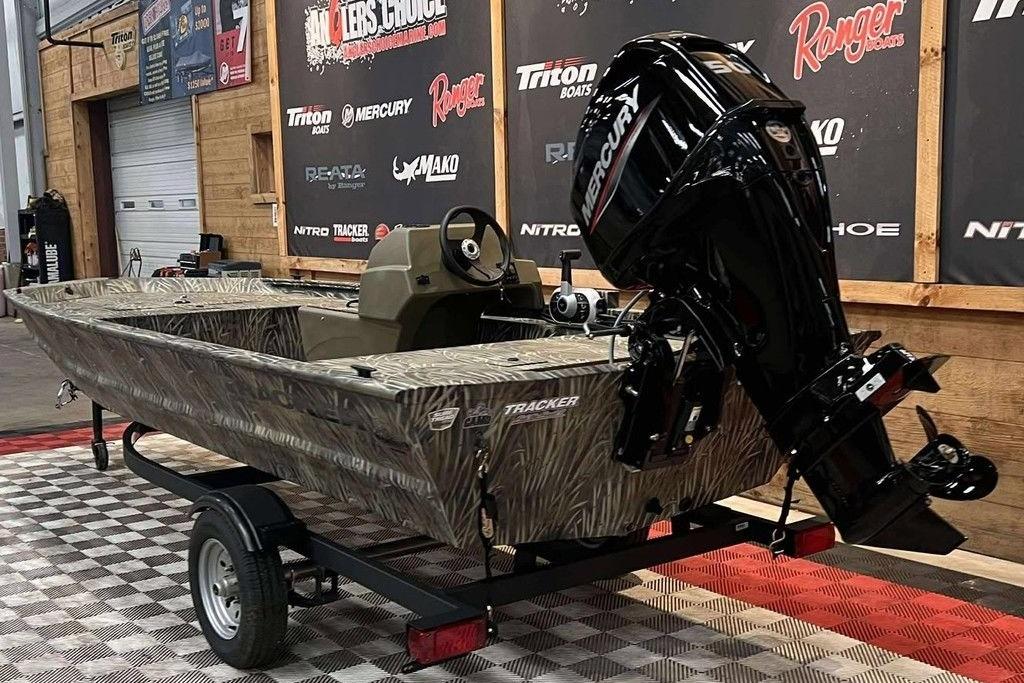 2026 Tracker Grizzly 1648 SC boat with Mercury engine on display in showroom.