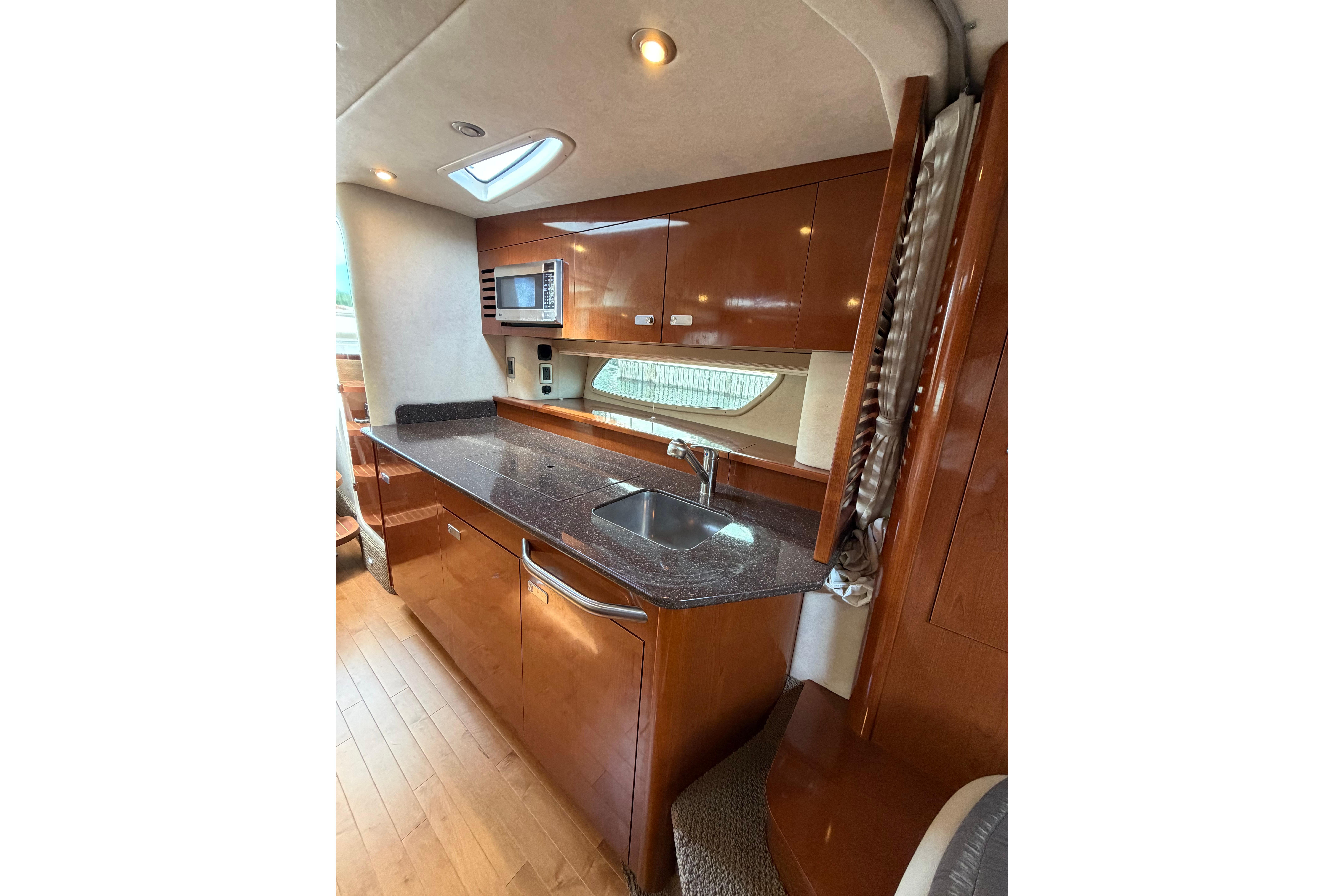 Luxurious 2012 Sea Ray Sundancer 370 yacht interior with modern kitchen amenities.