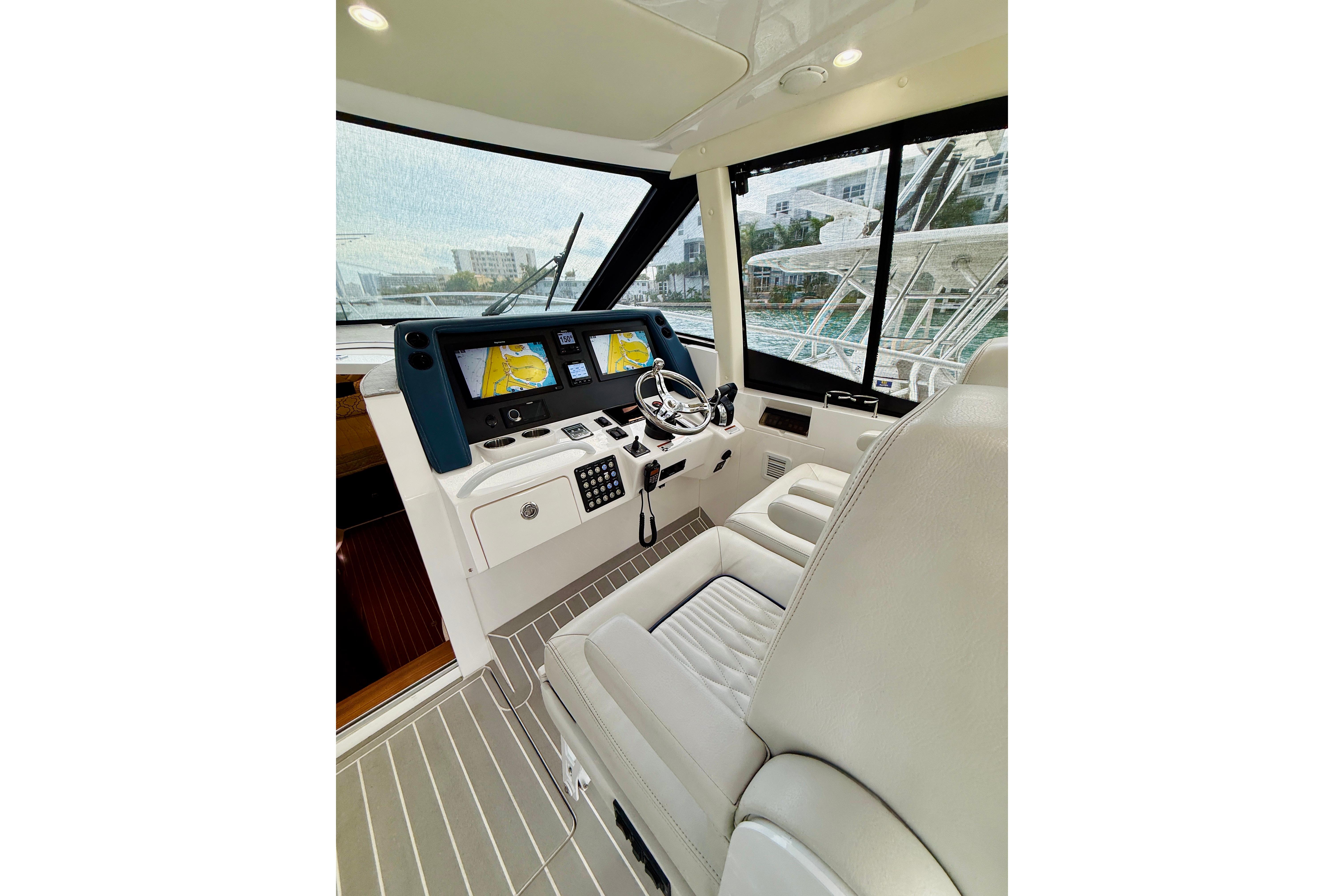 2021 Intrepid 410 Evolution yacht helm with modern navigation displays and luxurious seating.