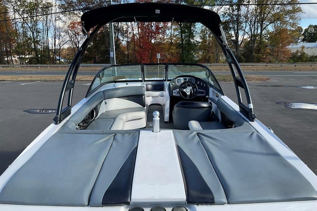 2015 Moomba Outback V boat interior with seating and steering wheel, parked outdoors.
