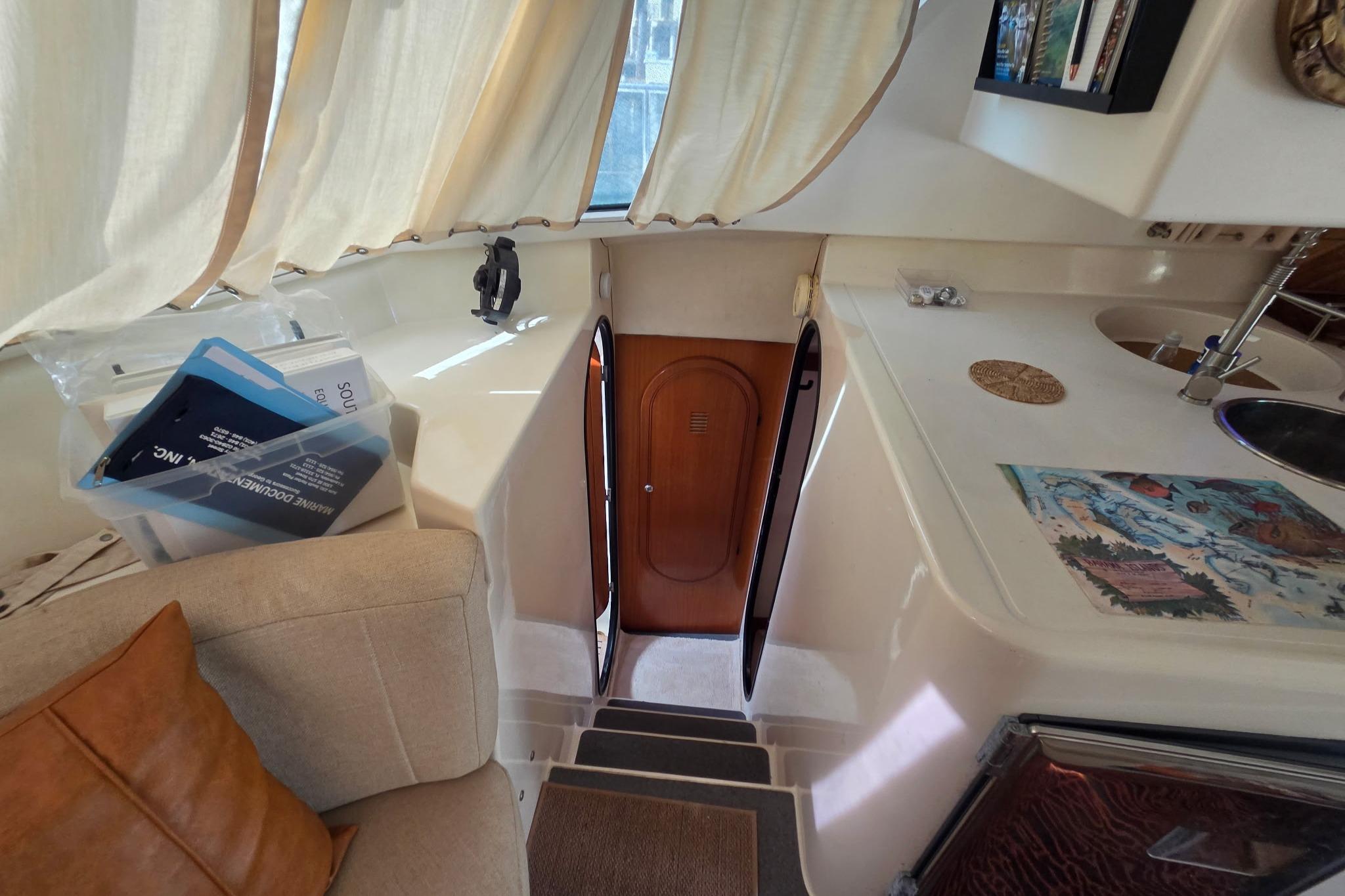 Interior of 2000 Fountaine Pajot Maryland 37 yacht, featuring cozy seating and nautical decor.