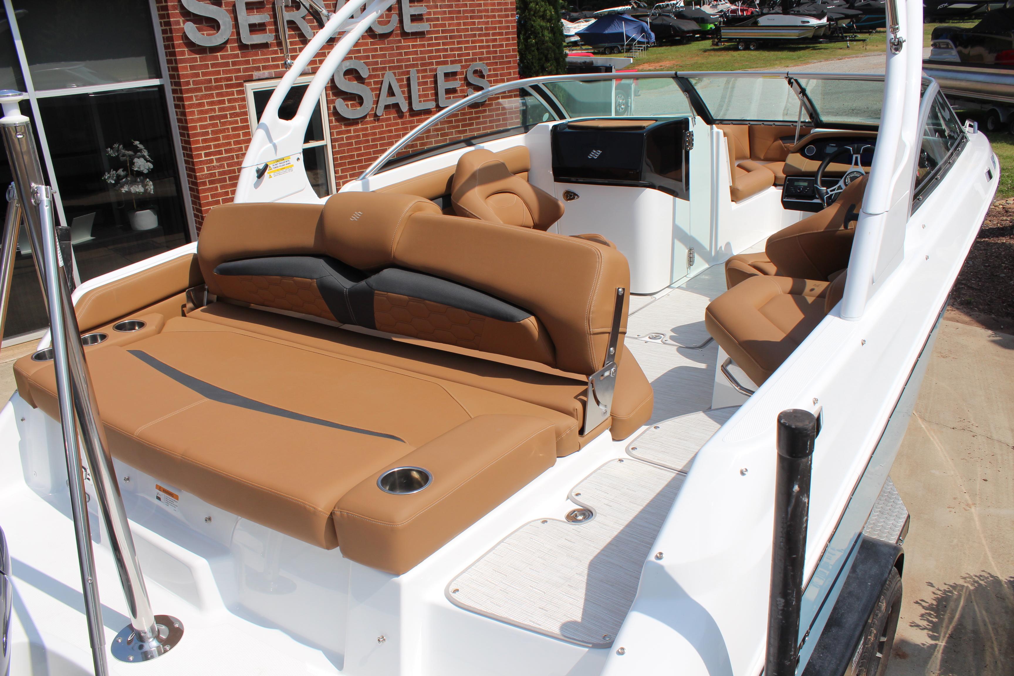 2025 Four Winns HD3 OB boat with tan seating, showcased at a sales service location.