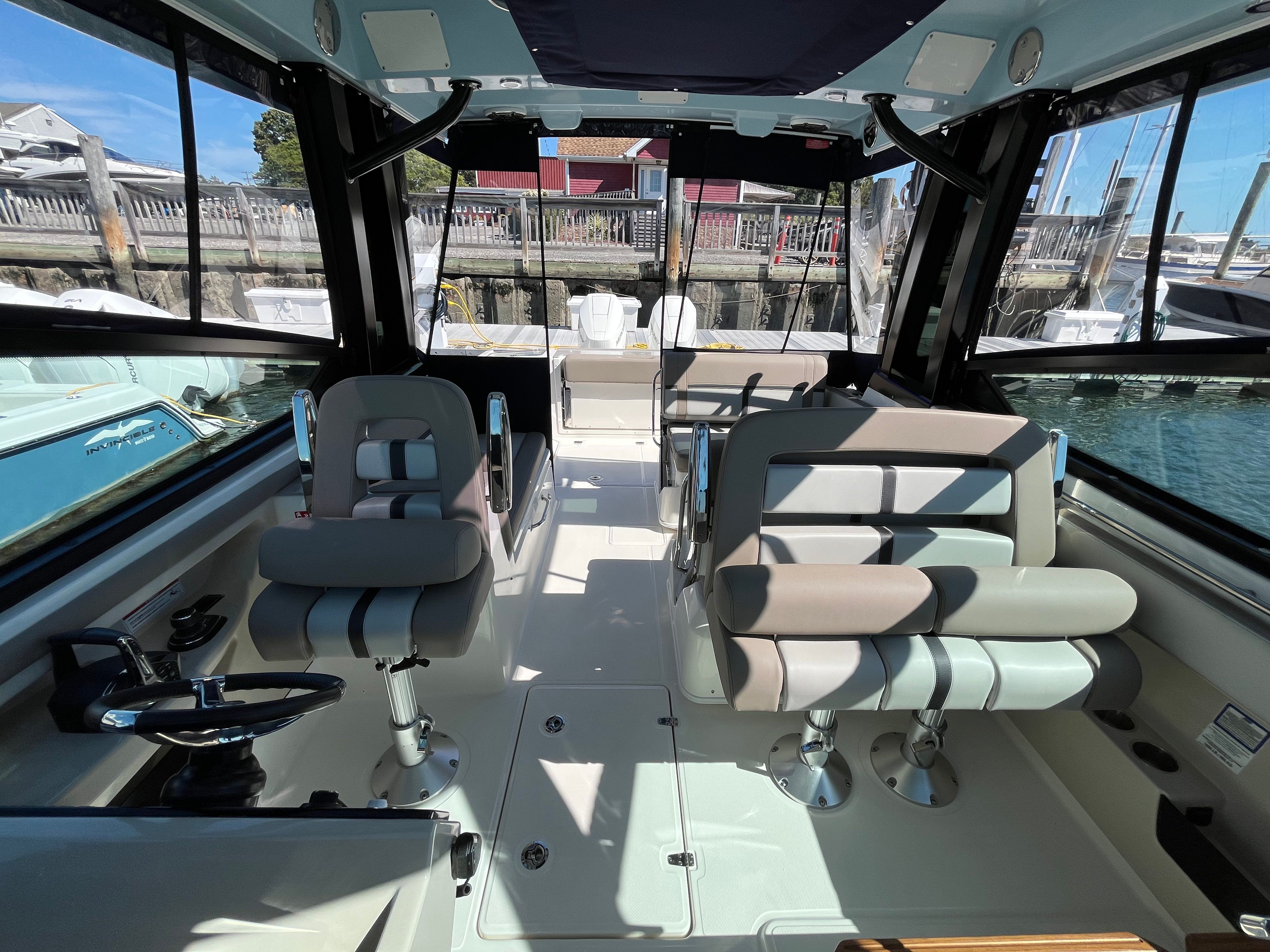 Interior view of a Boston Whaler 330 Vantage with modern seating and helm.
