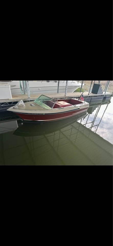 1965 Century Sabre boat docked on calm water.