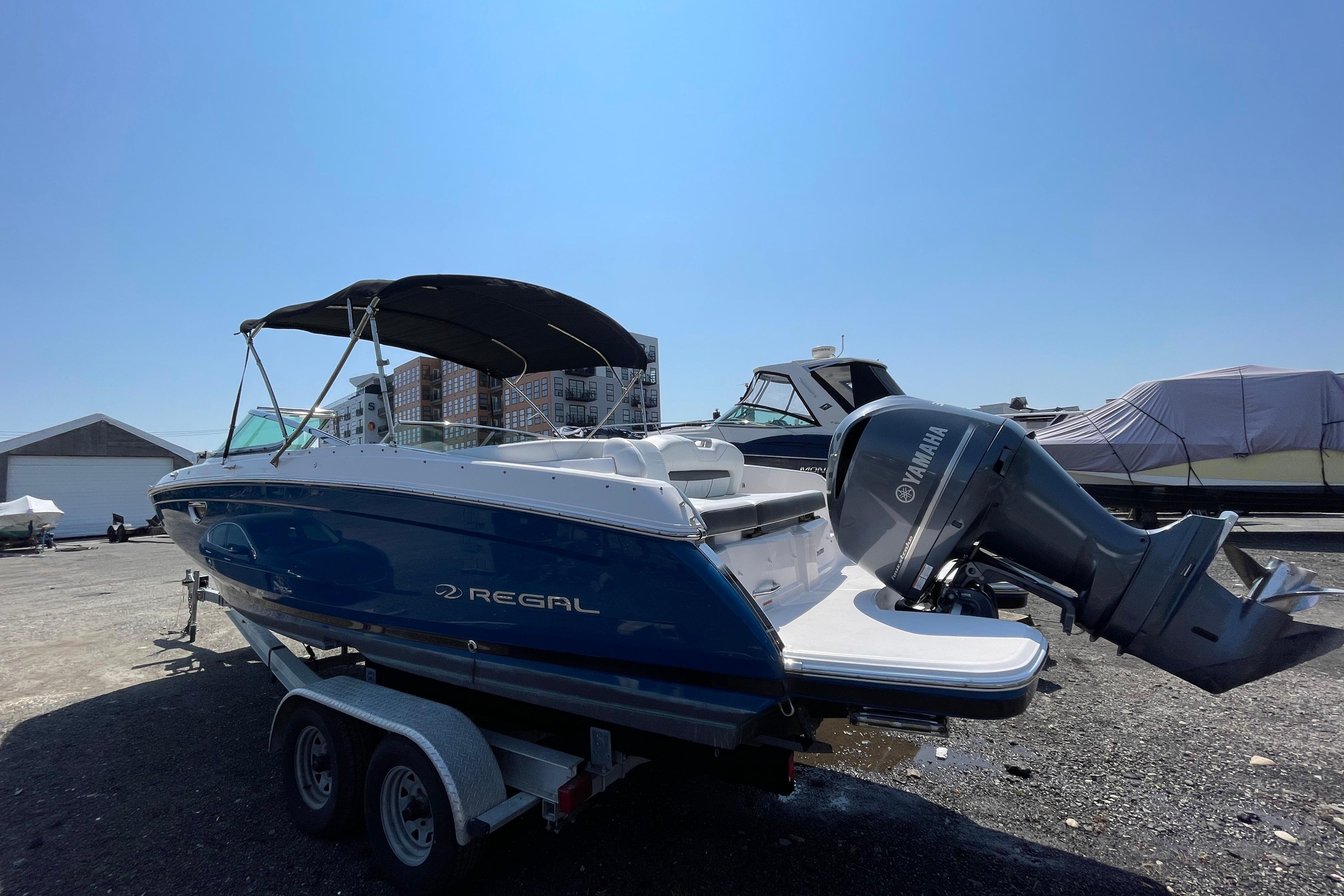 2018 Regal 26 OBX boat with Yamaha outboard motor on trailer, sunny day.