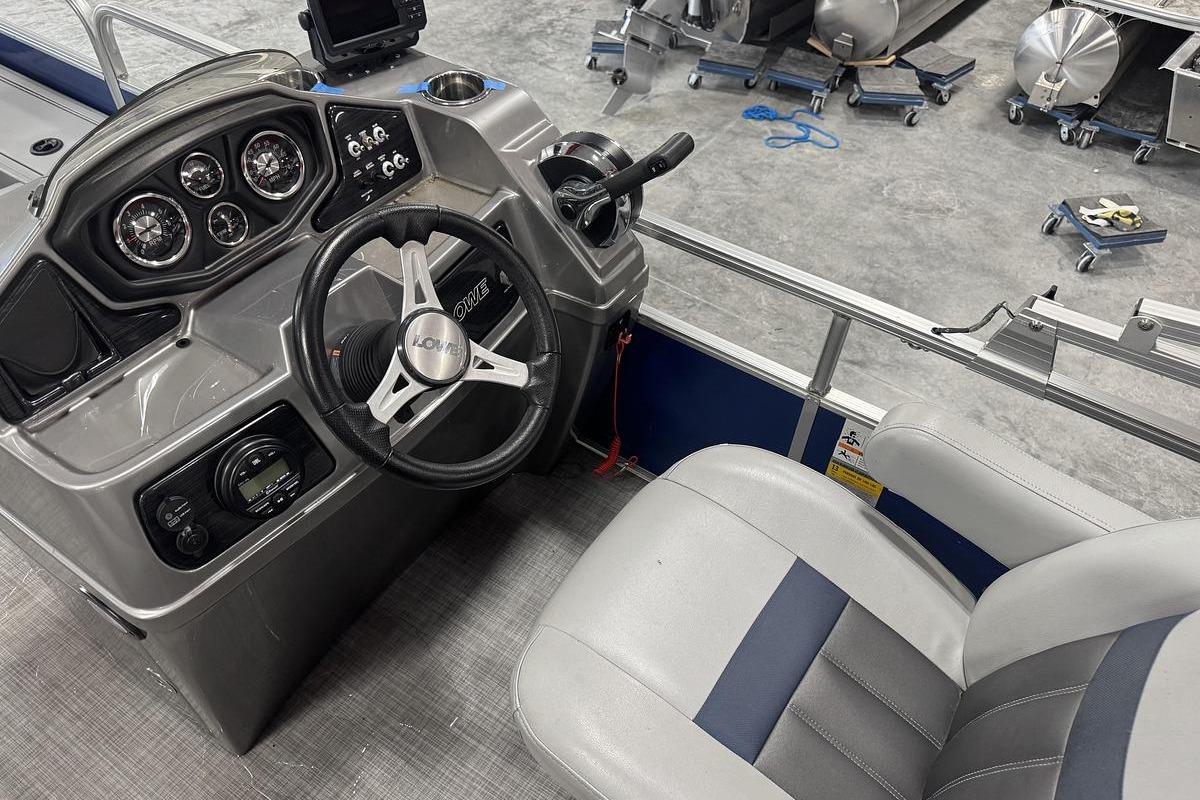 2018 Lowe SF 214 Sport Fish boat dashboard with steering wheel and gauges.