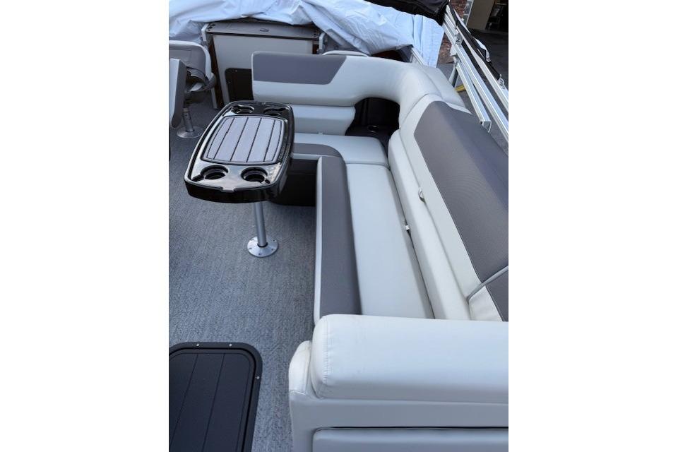 2026 Sun Tracker Fishin' Barge 22 XP3 interior with seating and table.