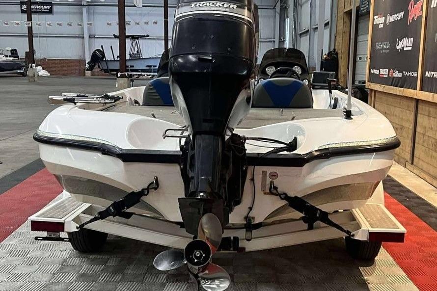 2005 Nitro NX 750 boat with Tracker motor in a showroom.