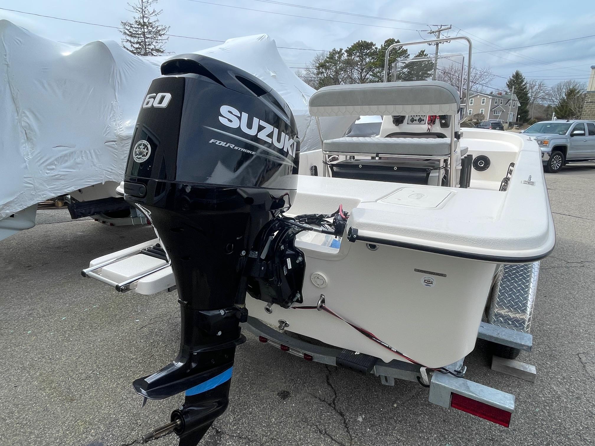 2025 Carolina Skiff E16 JVX CC boat with Suzuki outboard motor on trailer.