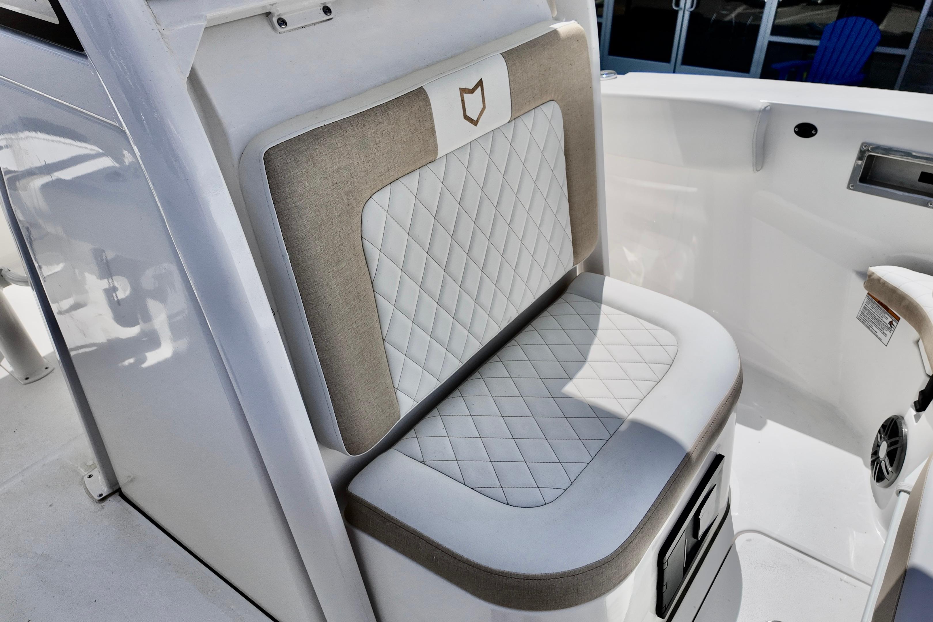 2026 Sea Fox 228 Commander boat seat with quilted upholstery and storage compartment.