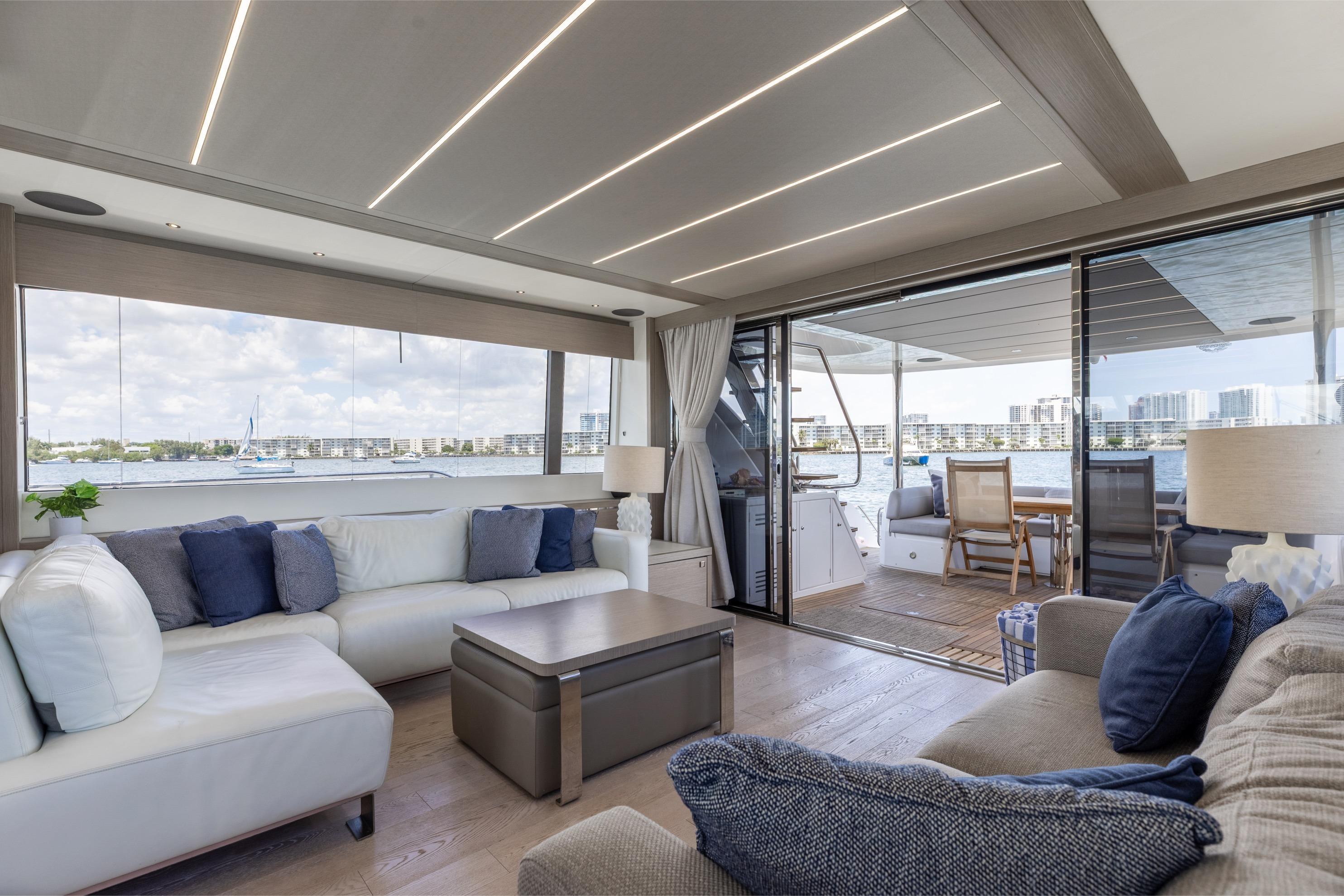 Luxurious interior of 2022 Sunseeker 76 Yacht with waterfront view and elegant furnishings.