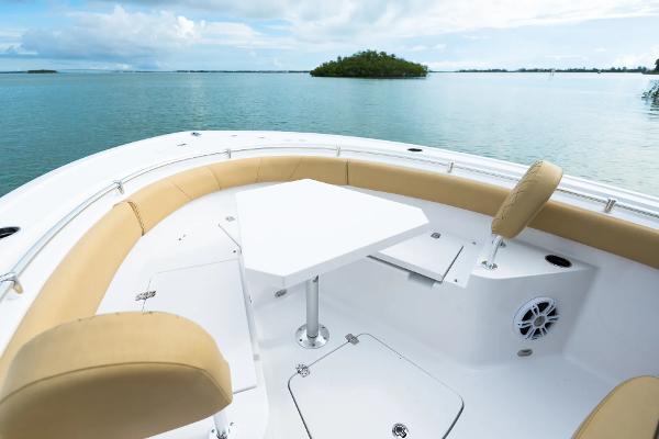Manufacturer Provided Image: 2025 Sportsman Heritage 231 Center Console boat with seating and table on calm water.