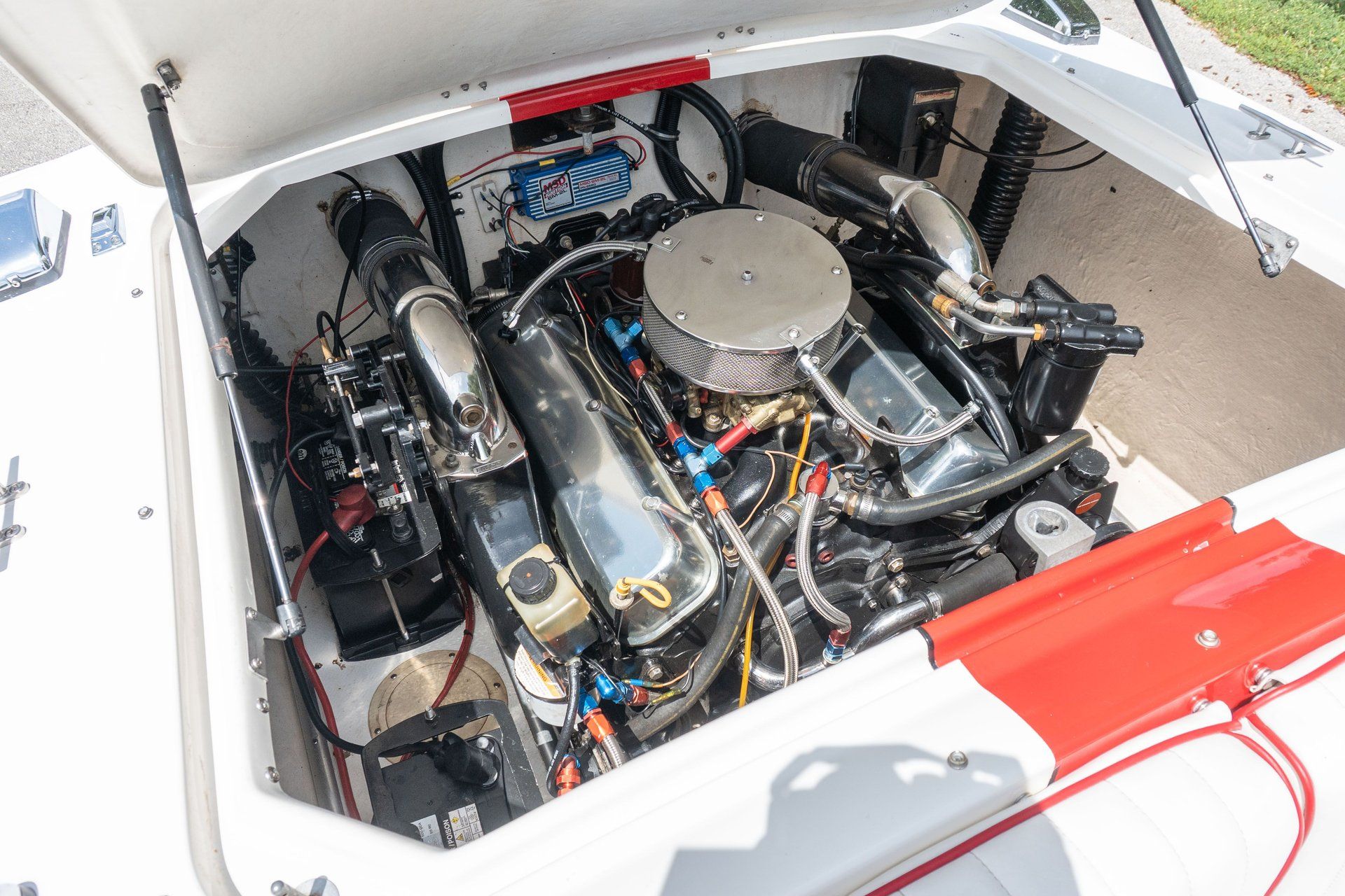 Engine compartment of a 1995 Donzi Classic with shiny metal parts and wiring.
