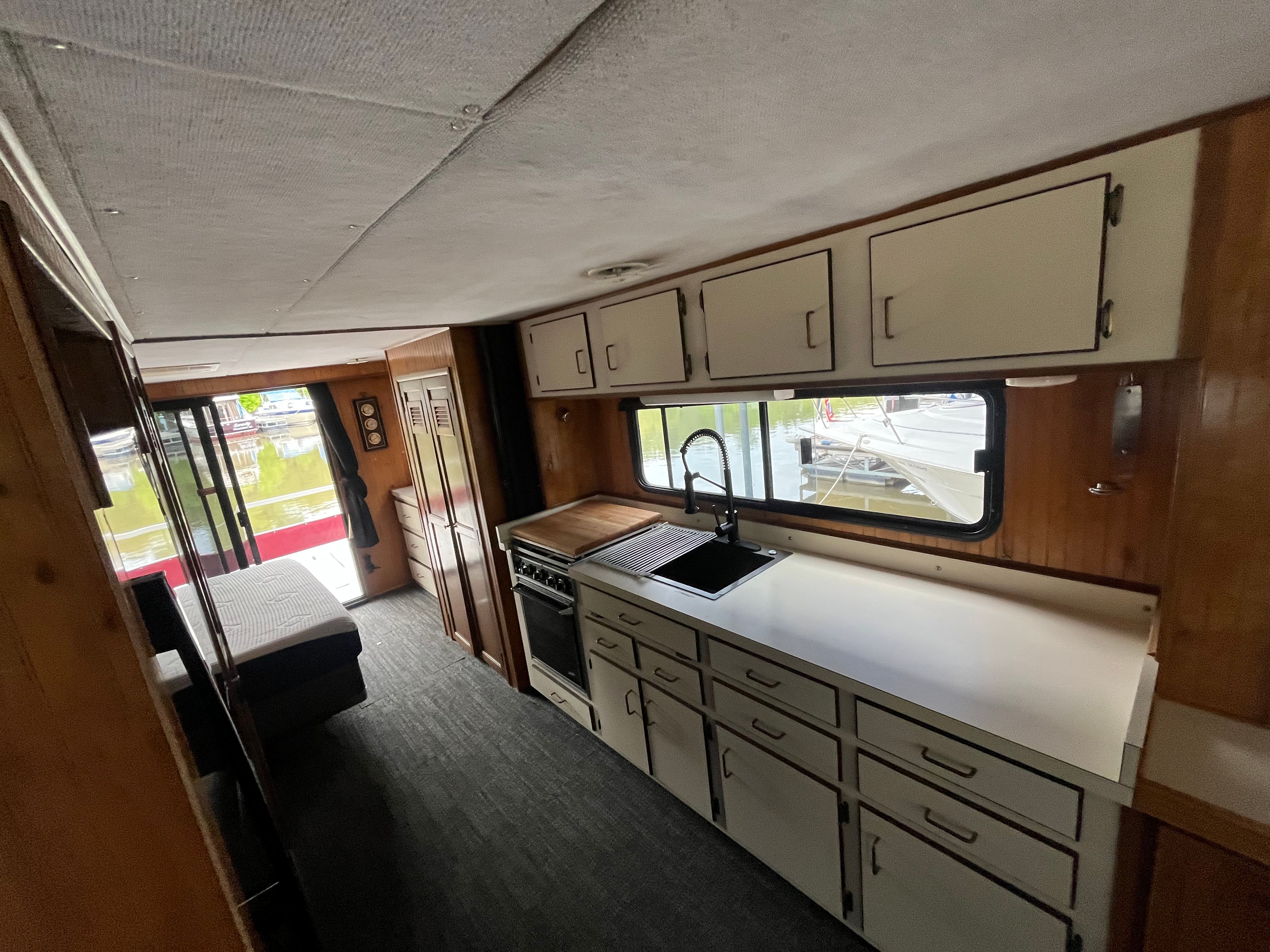 Interior of a 1995 Gibson Executive with kitchen and sleeping area.