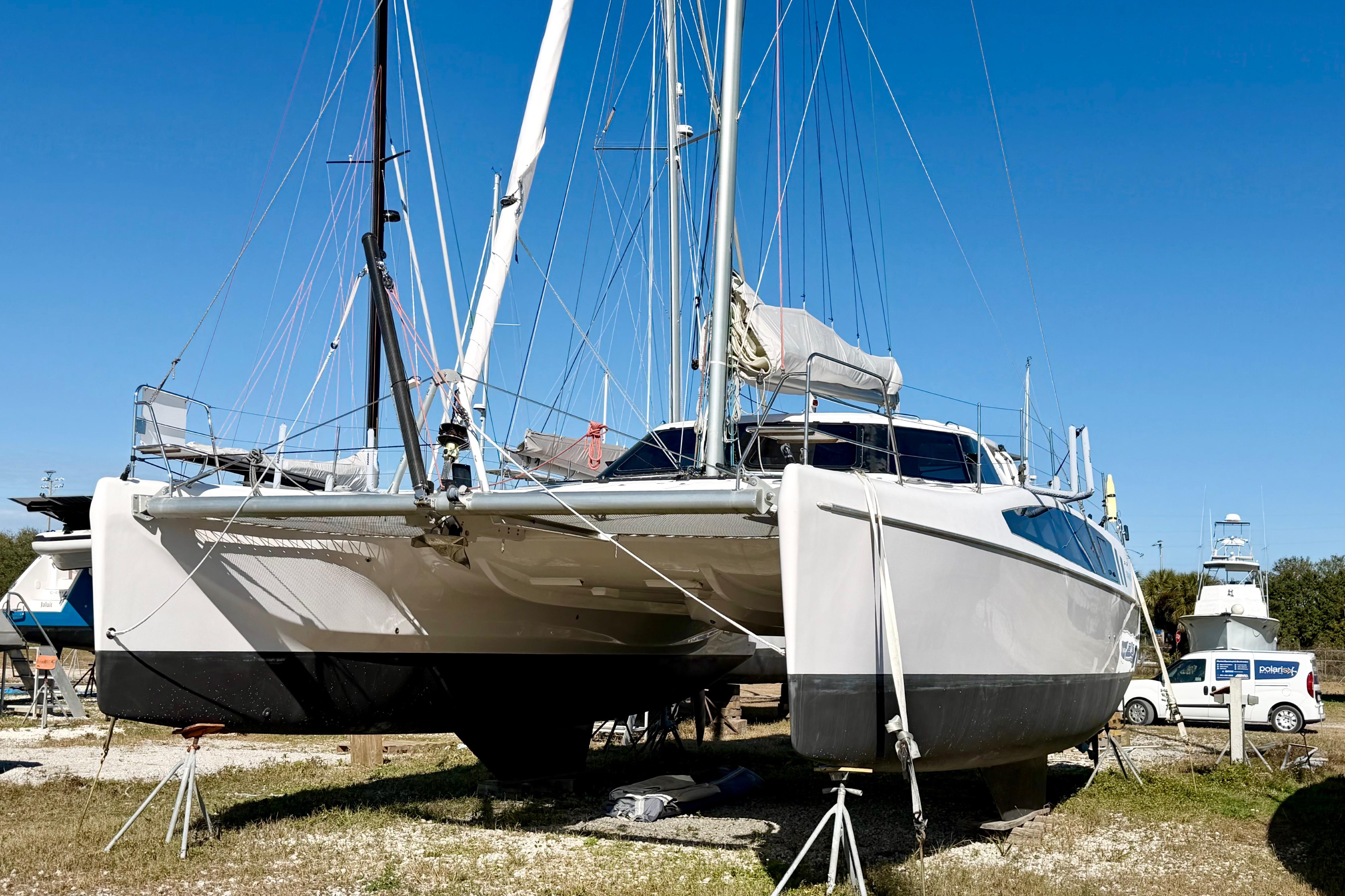 2020 Seawind 1260 catamaran on land, blue sky background, ready for maintenance.