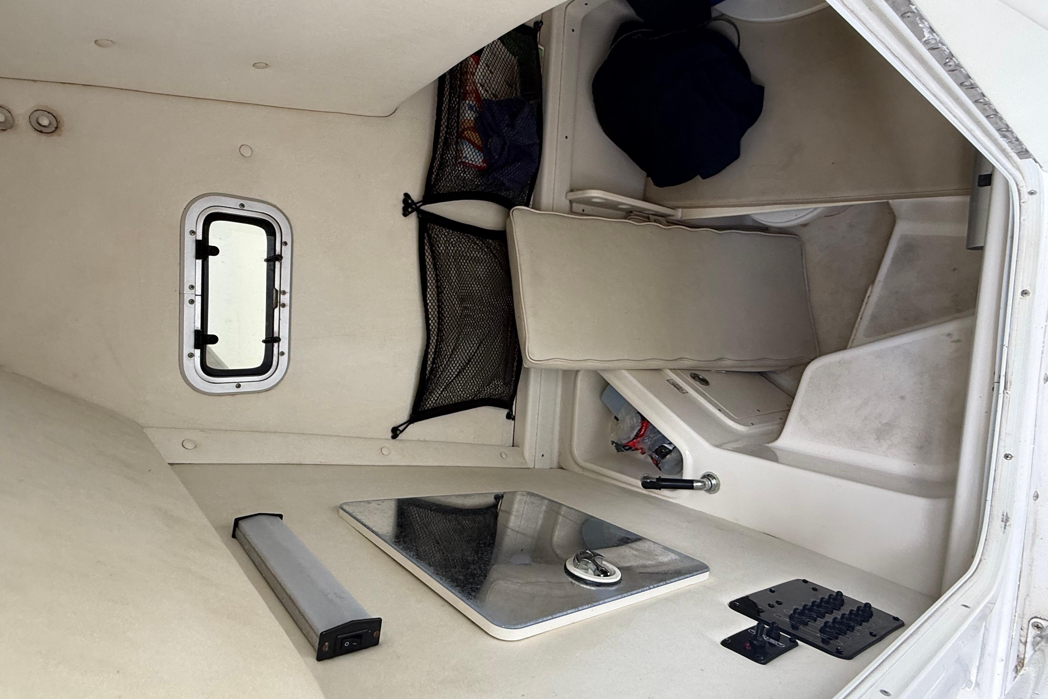 Interior cabin of a 2008 Century 2901 Center Console boat, featuring seating and storage.