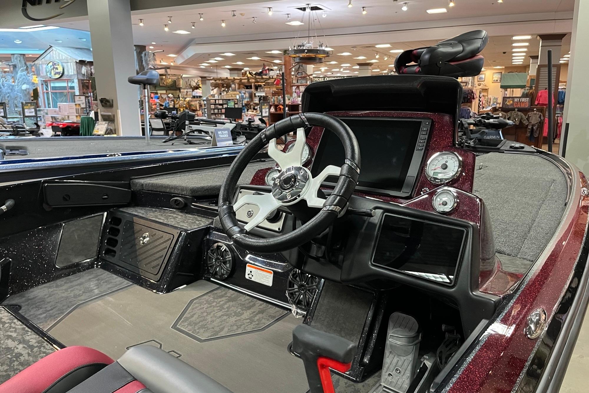 2026 Nitro Z21 XL Pro boat interior with steering wheel and dashboard in showroom.