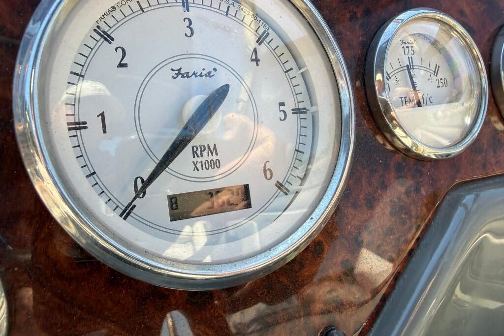 Close-up of 2007 Regal 2565 Window Express boat gauges, showing RPM and temperature.