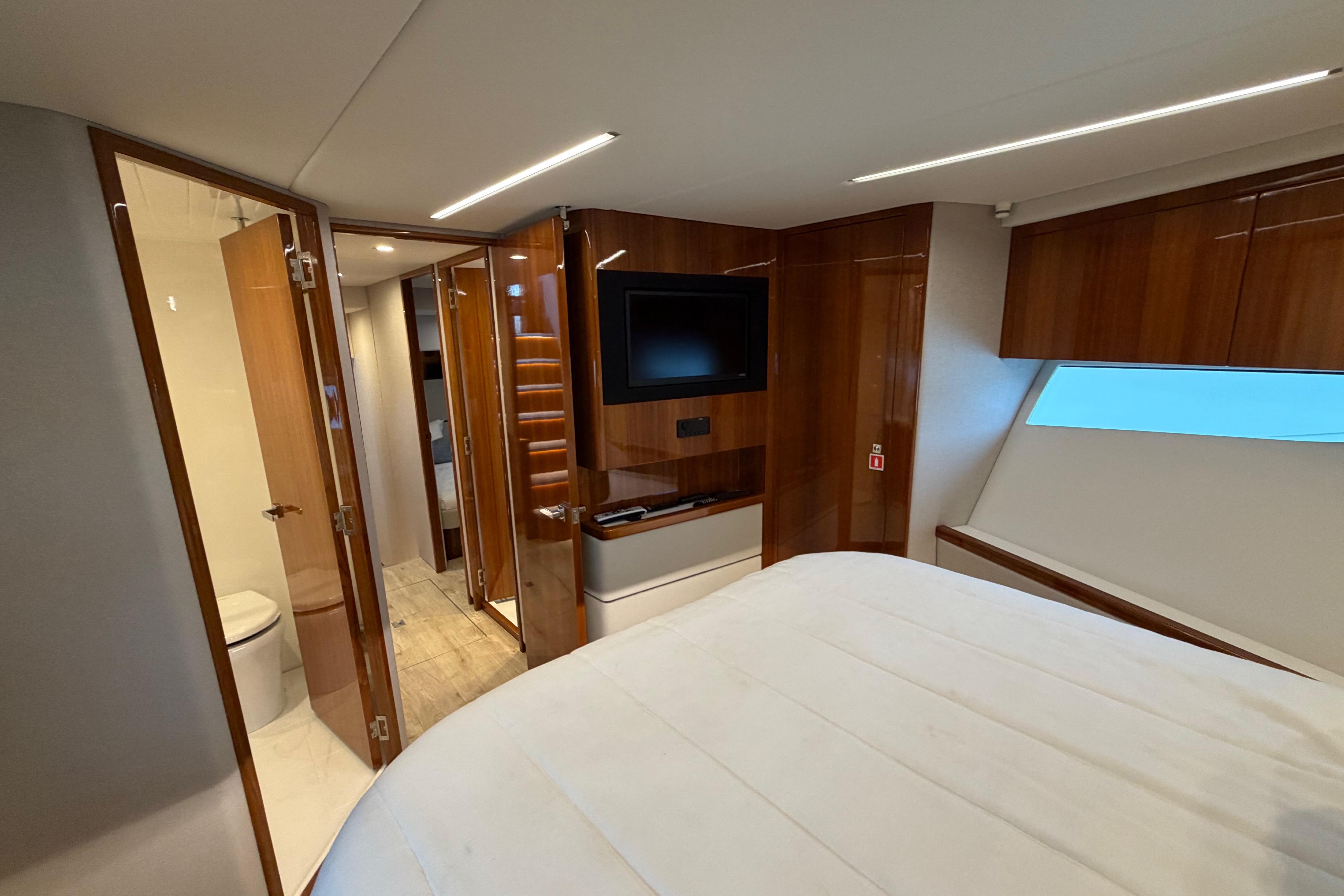 Luxurious interior of 2023 Riviera 645 SUV yacht with wood finishes and modern amenities.