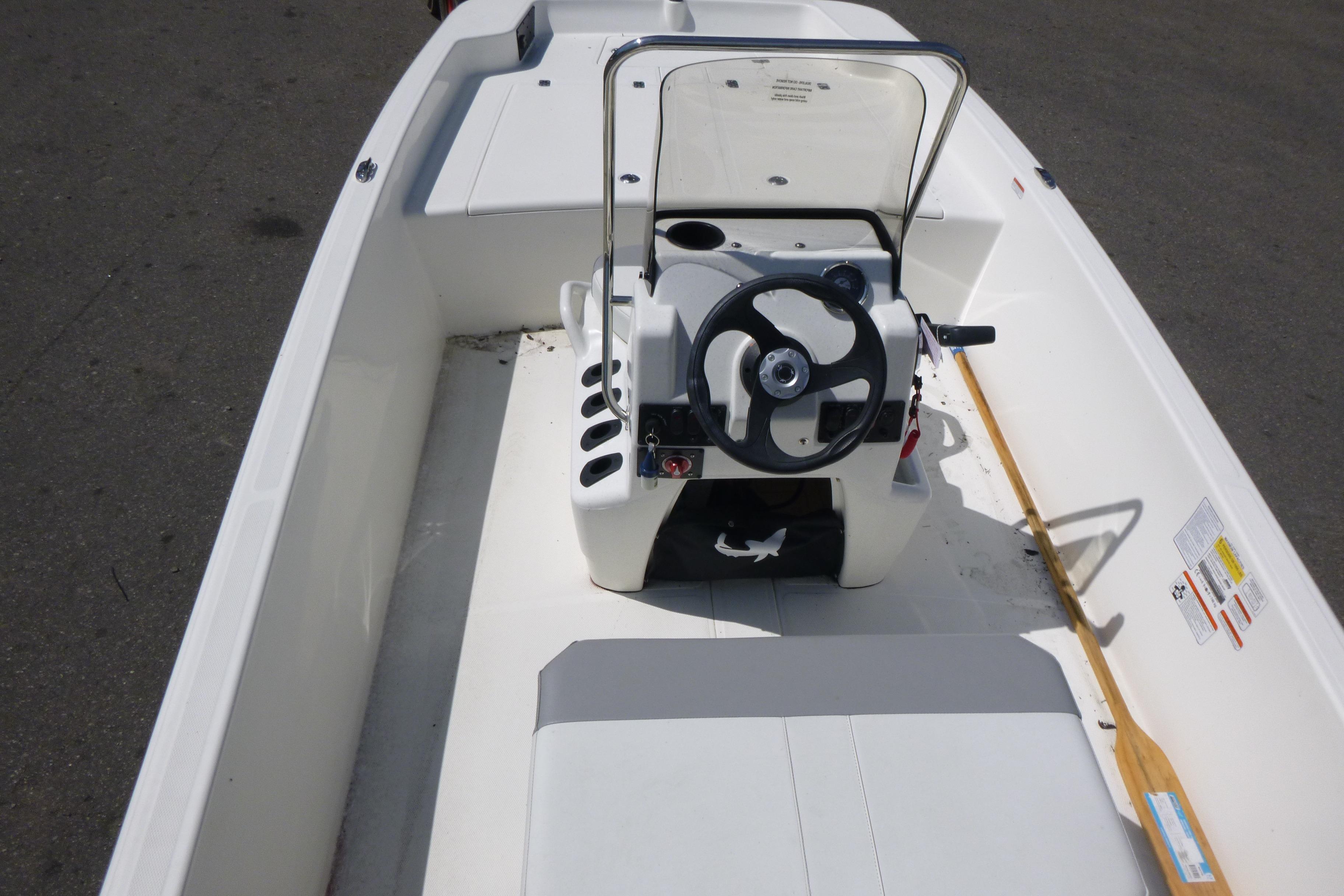 2024 Mako Pro Skiff 17 CC boat interior with steering console and seating.