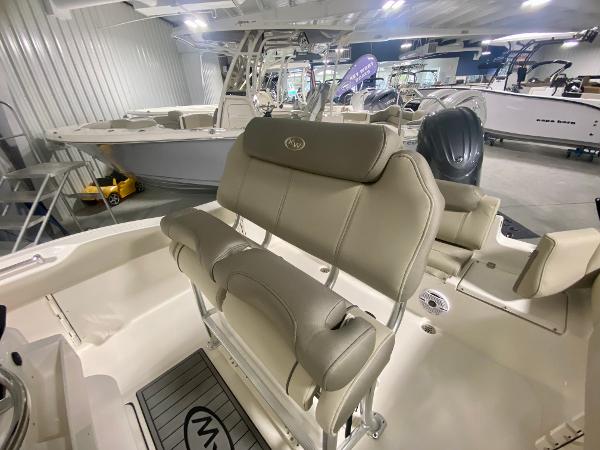 2024 Key West 219 FS boat interior with beige seating in showroom.