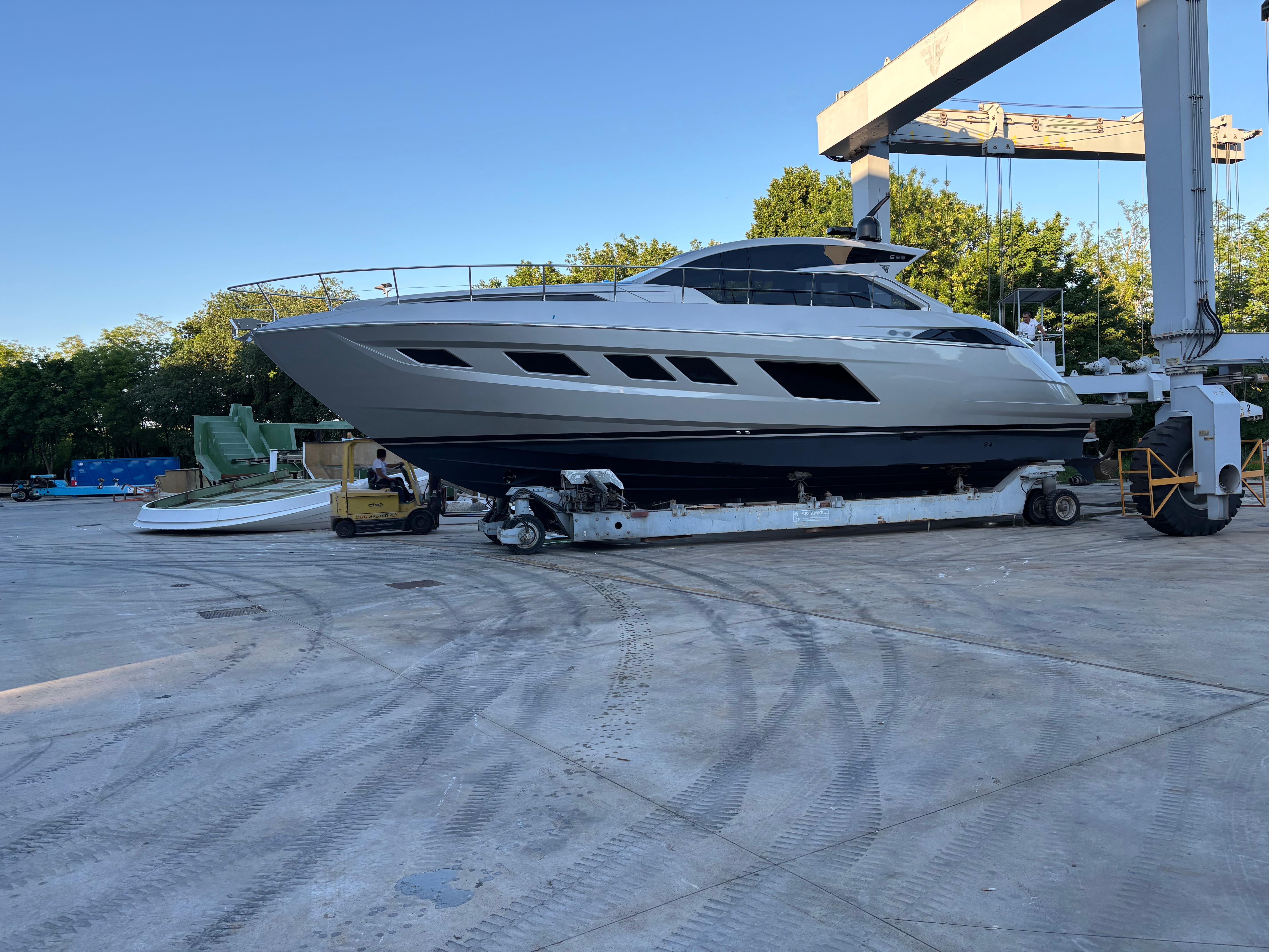 2025 Filippetti S55 yacht on a trailer in a shipyard setting.