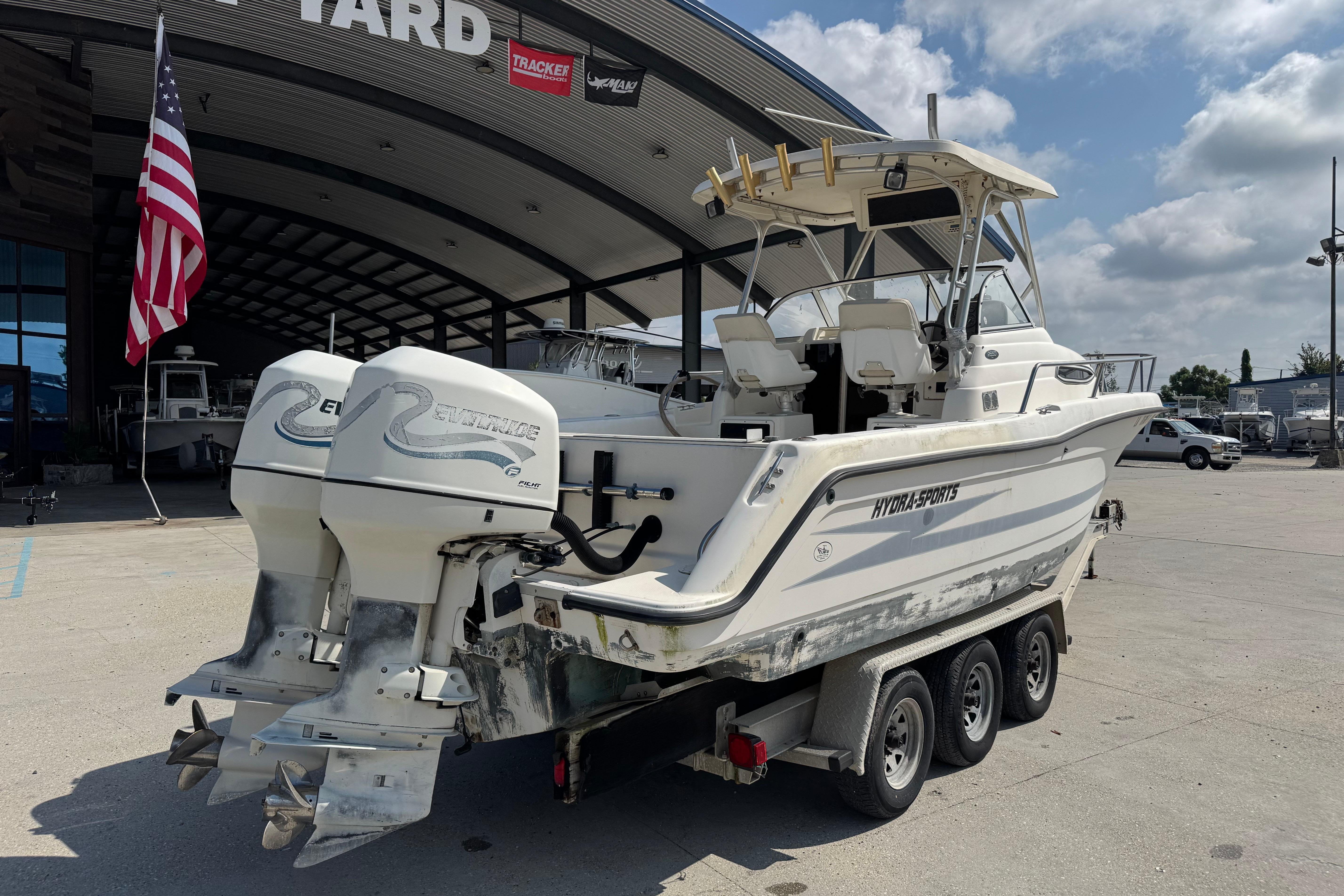 1997 Hydra-Sports VECTOR 2650 WA boat with dual Evinrude engines on a trailer.