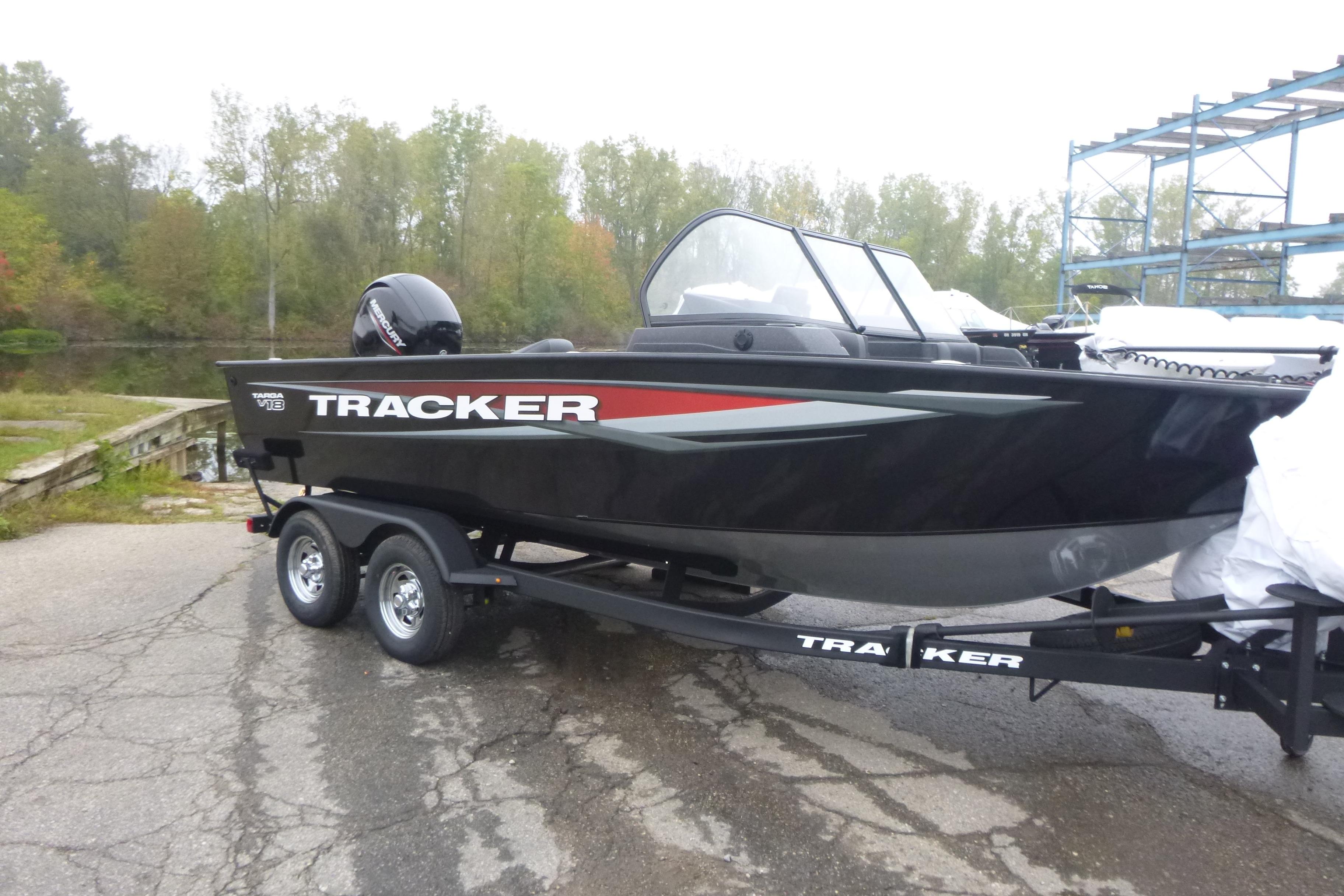 2026 Tracker Targa V-18 Combo boat on trailer, parked near a lake.