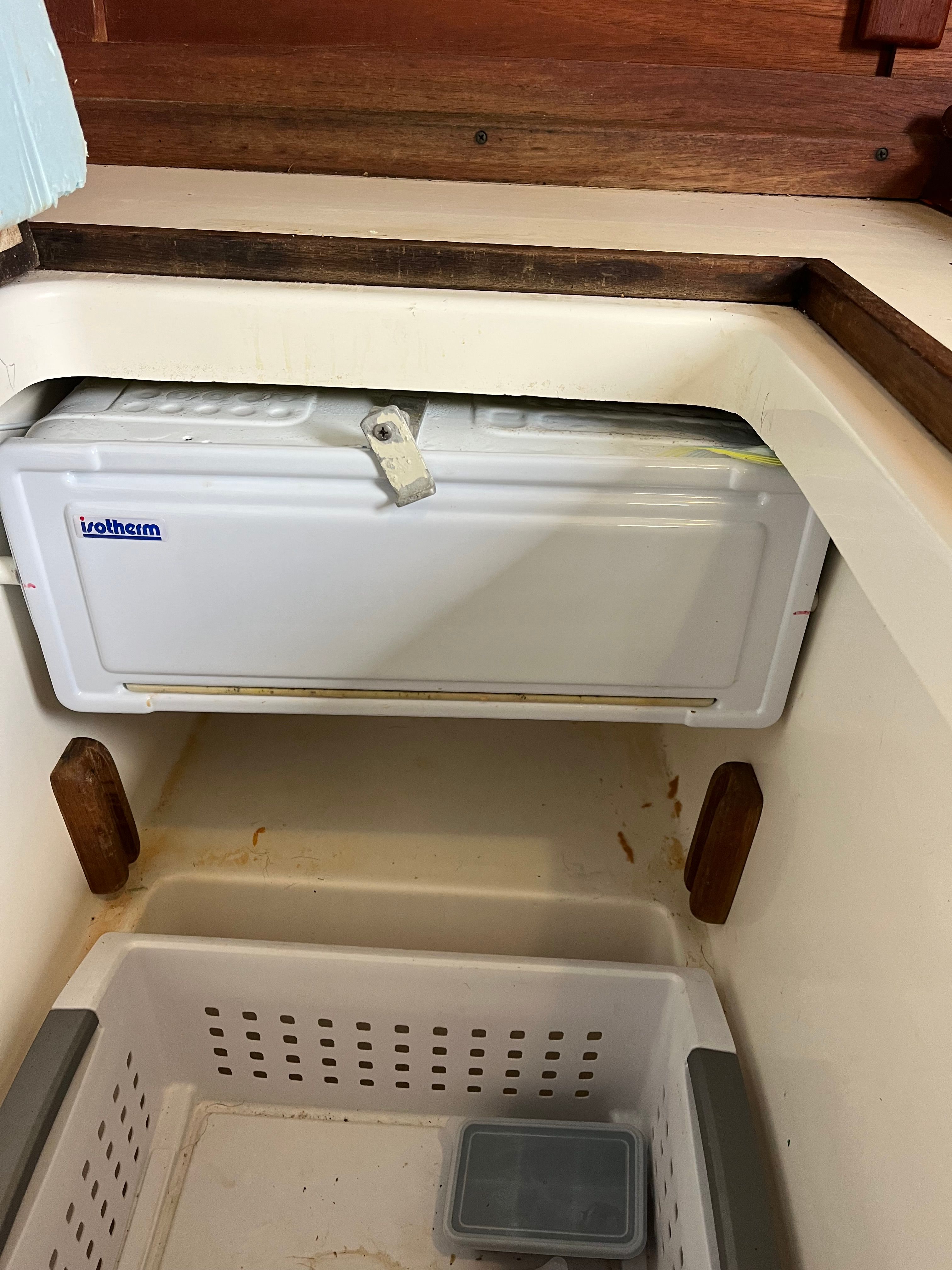 Interior of a 1981 Tartan Sloop with a fridge and storage space.