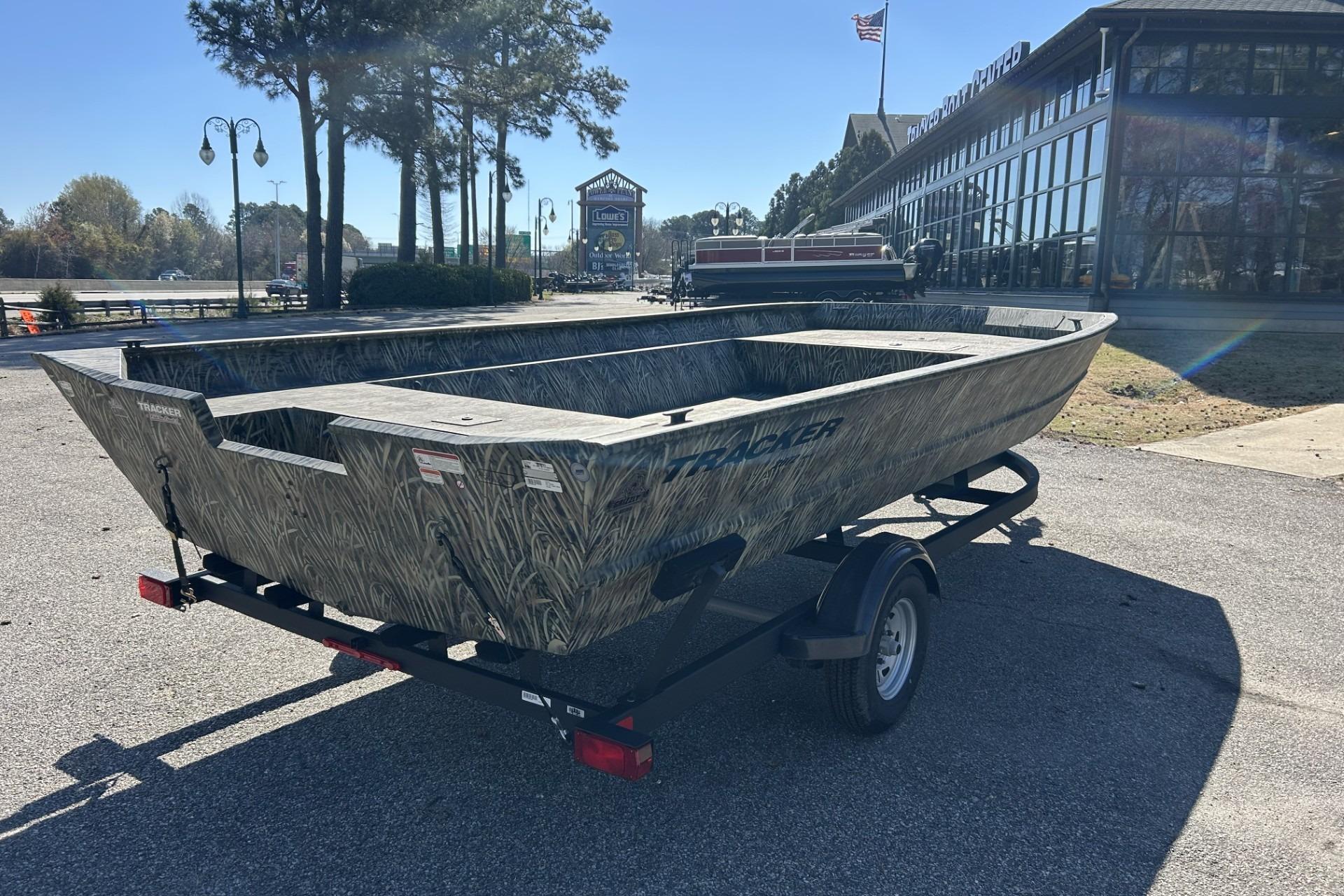 2025 Tracker Grizzly 2072 Utility boat on trailer, parked outdoors near a building.