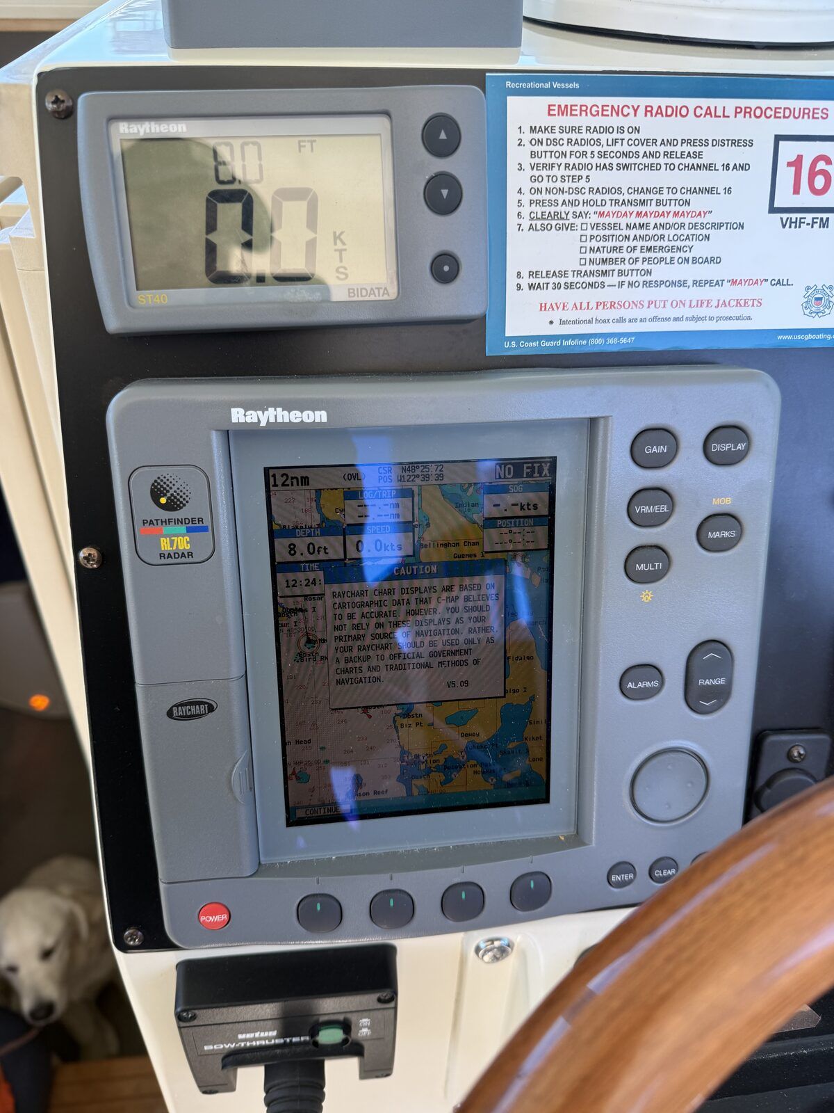 Navigation system on a boat with map display and speedometer.