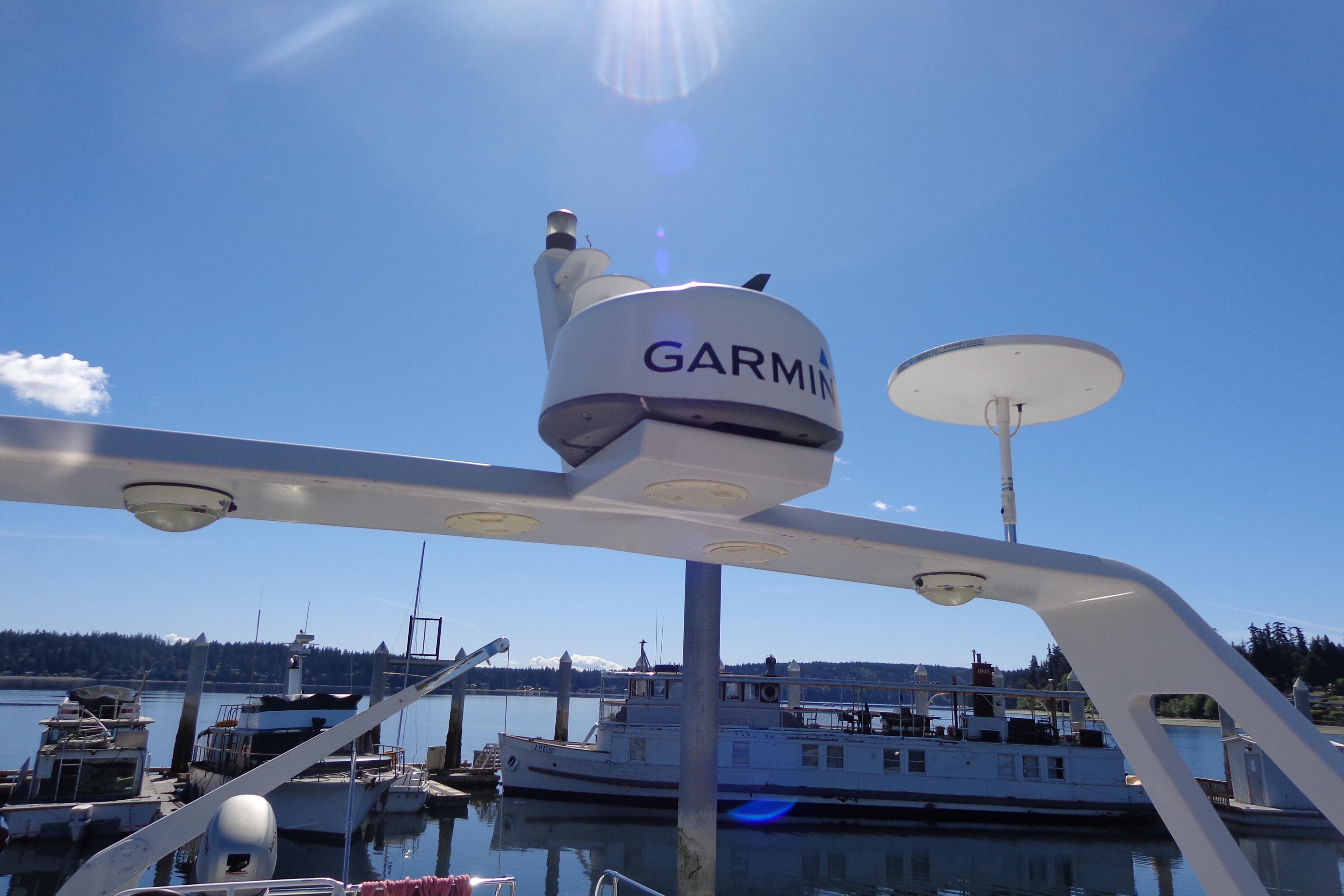 Garmin radar on 1992 Cruise-A-Home Corsair 4200, docked under clear blue sky.